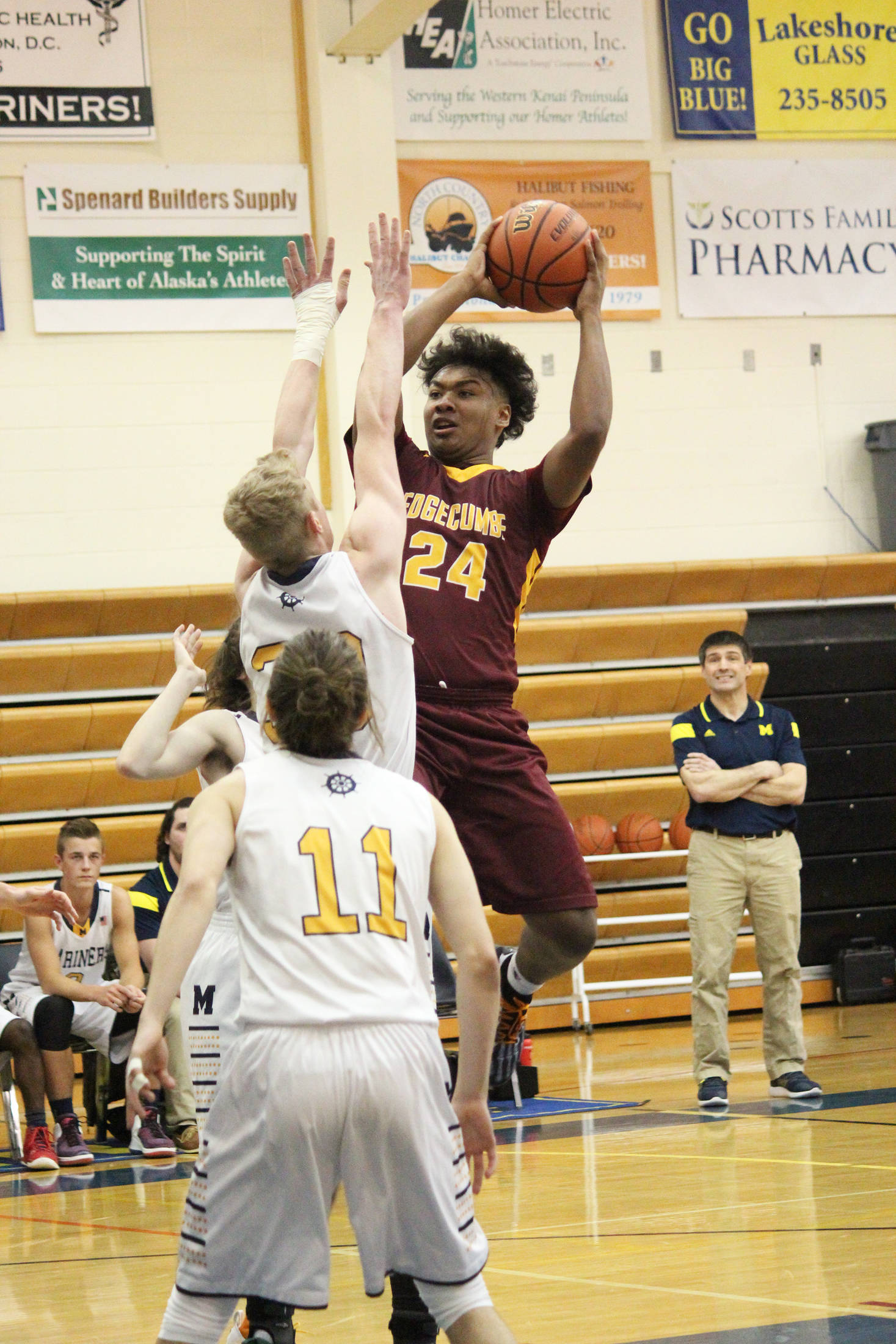 Mt. Edgecumbe’s Emmett Dunaway attempts a shot under pressure from several Mariners during a Thursday, Jan. 10, 2019 game in Homer, Alaska. (Photo by Megan Pacer/Homer News)