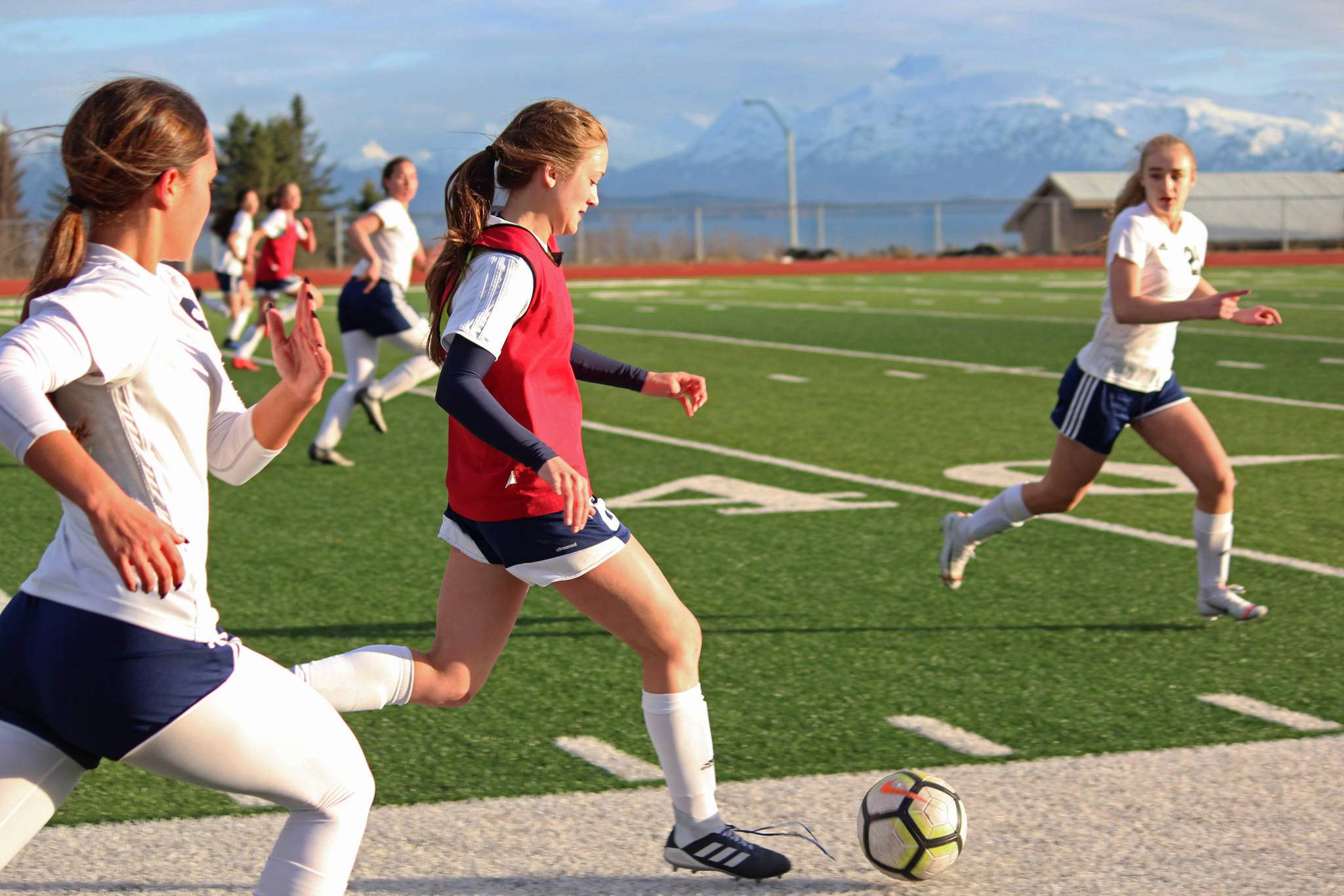 Homer’s Eve Brau takes the ball up the field during a game against Soldotna High School on Tuesday, April 9, 2019 in Homer, Alaska. The teams tied the game 3-3. (Photo by Megan Pacer/Homer News)