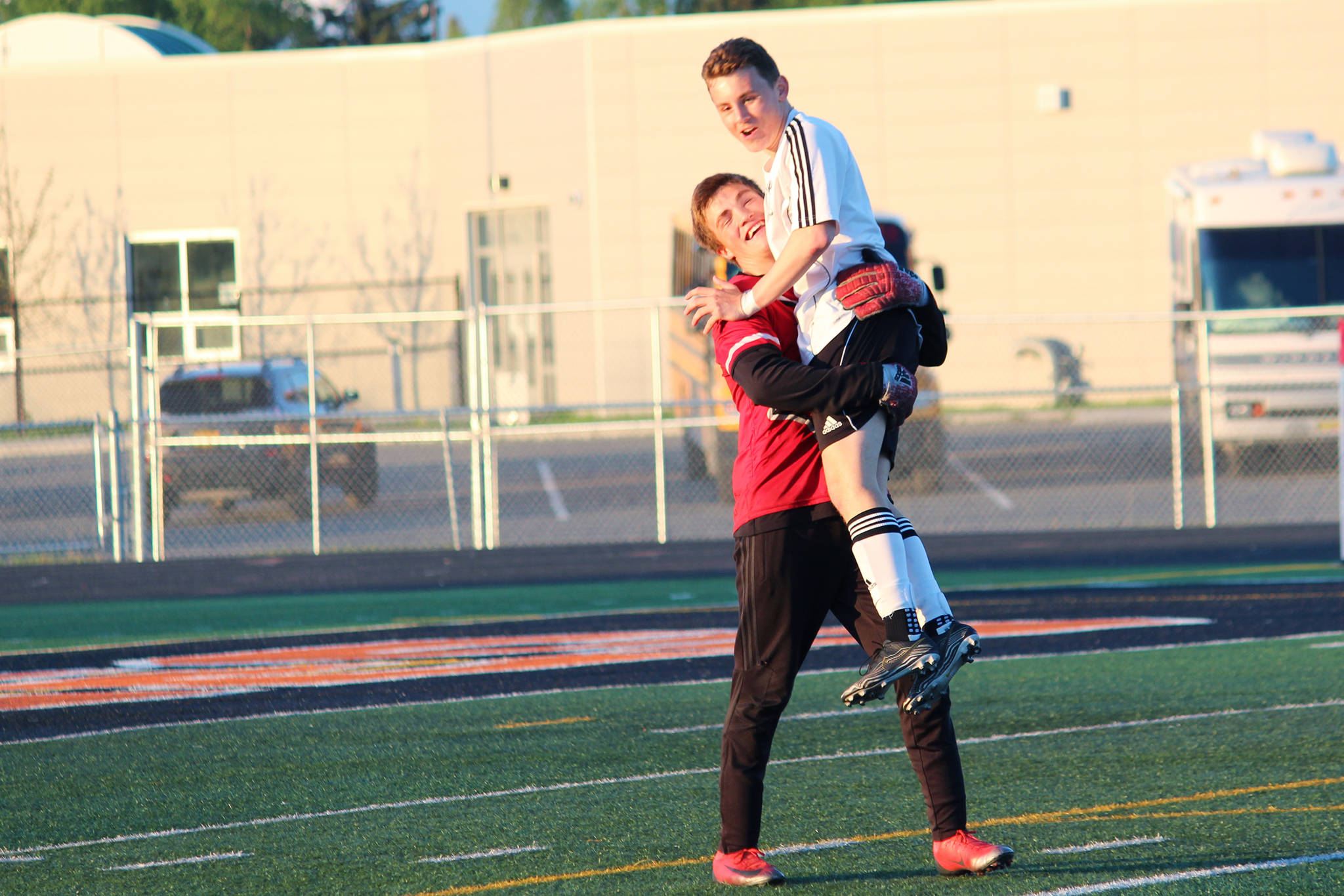 Braedon Pitsch (left) and Travis Verkuilen celebrate their win over Ketchikan in a Friday, May 24, 2019 semifinal match during the Division II state soccer championships at West Anchorage High School in Anchorage, Alaska. (Photo by Megan Pacer/Homer News)