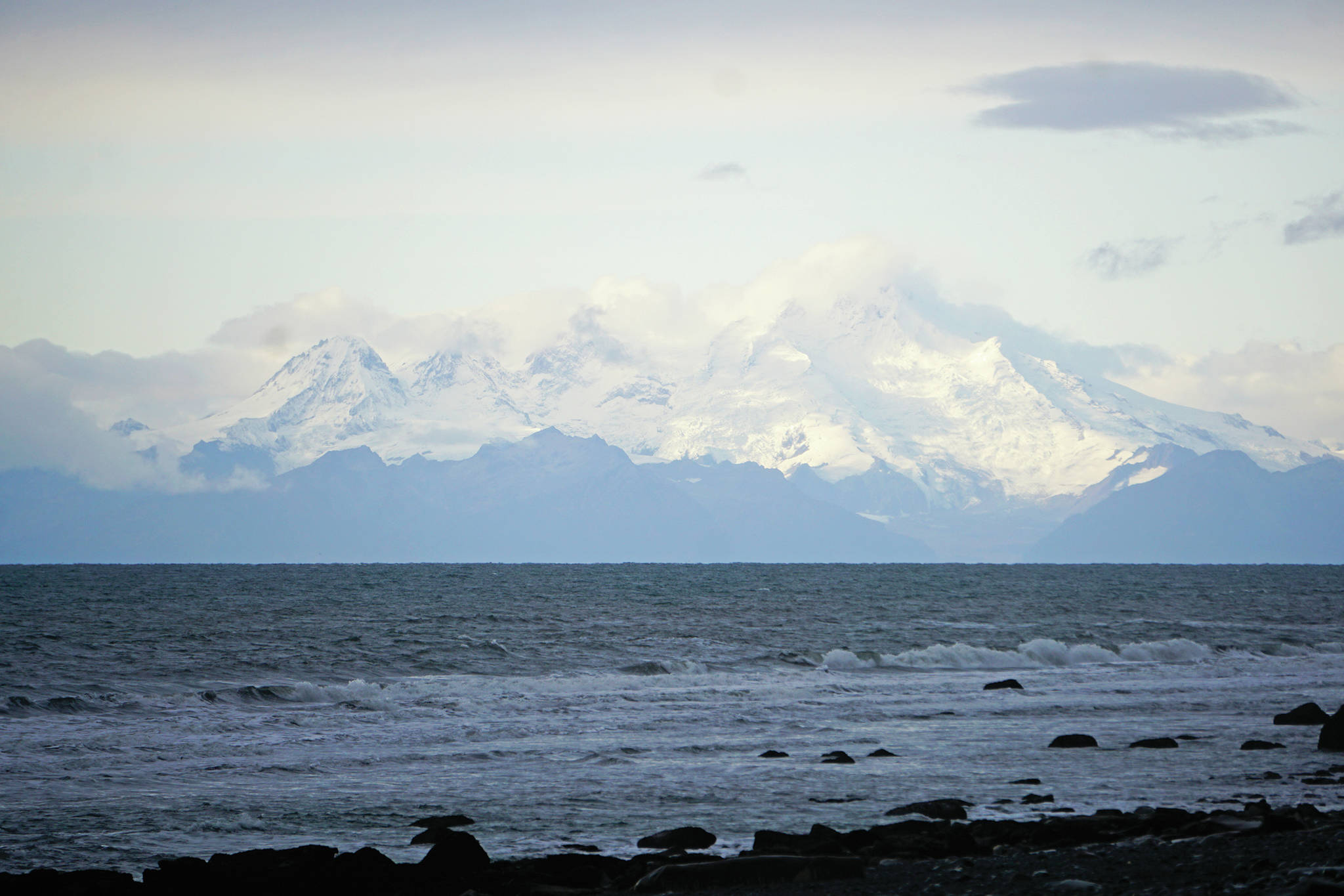 Storm clouds swirl around Mount Iliamna on Saturday, Oct. 5, 2019, as seen from the Diamond Creek beach near Homer, Alaska. (Photo by Michael Armstrong/Homer News)