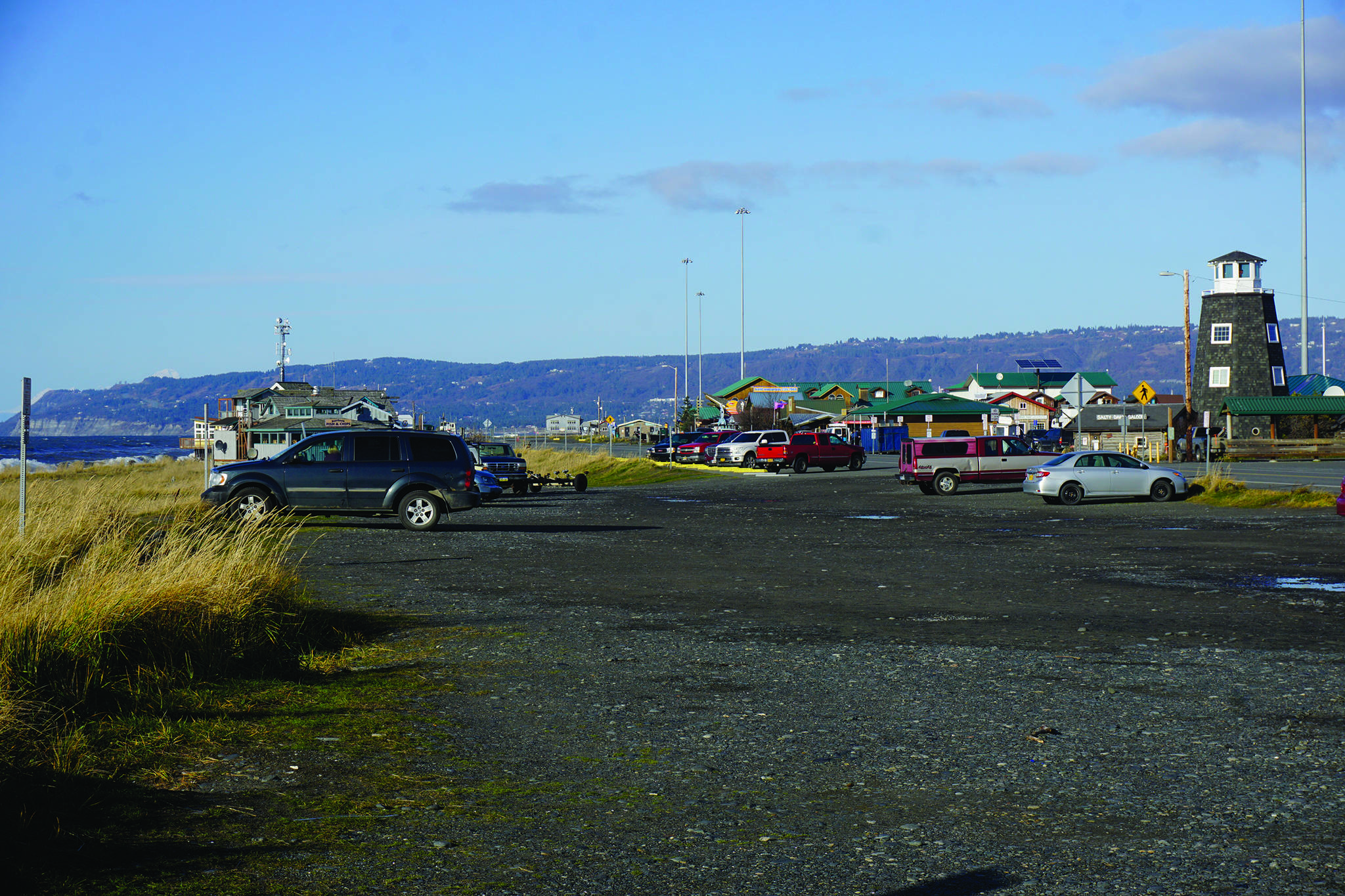 The Seafarers Memorial parking lot is mostly empty on Oct. 25, 2019, on the Homer Spit in Homer, Alaska. The city has applied for a conditional use permit to fill in and extend the parking lot to the left in this photo, or toward the beach. The angled parking spaces by the Homer Spit Road also would be removed except in front of the Cannery Row Boardwalk.(Photo by Michael Armstrong/Homer News)