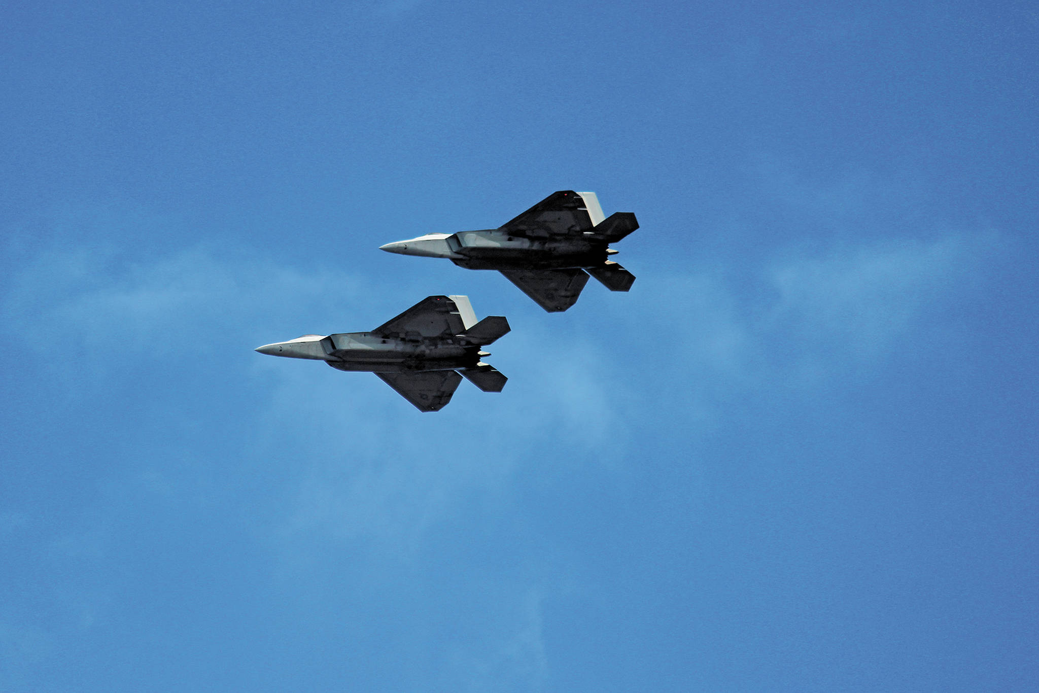 Two F-22 Raptors fly over Beluga Lake on Friday, May 15, 2020 as part of a statewide flyover event put on by the U.S. Air Force and Air National Guard. Four of the aircraft flew over Homer, Alaska and other parts of the state as a way to show support for health care workers and other COVID-19 front line workers. (Photo by Megan Pacer/Homer News)