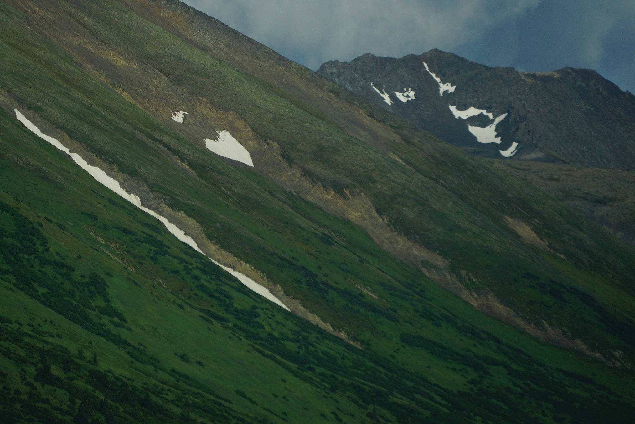 A patch of heart-shaped snow clings to the side of the Kenai Mountains on Tuesday, July 21, 2020, near Hope, Alaska. (Photo by Michael Armstrong/Homer News)