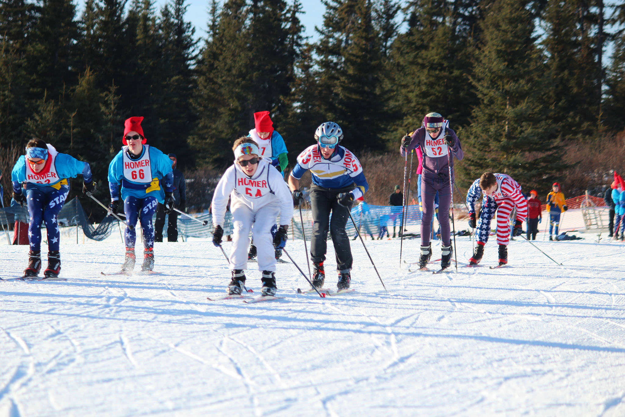 Varsity boy skiers take off from the starting line in a mass start for a 5 kilometer skate ski race Saturday, Feb. 3, 2018 at the Lookout Mountain Ski Trails near Homer, Alaska. (Photo by Megan Pacer/Homer News)