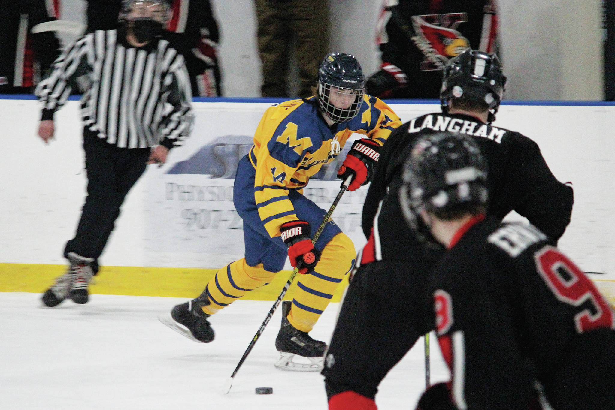 Homer’s Kazden Stineff looks for a way past Kenai’s Gavin Langham during a Friday, Feb. 5, 2021 hockey game at the Kevin Bell Arena in Homer, Alaska. (Photo by Megan Pacer/Homer News)