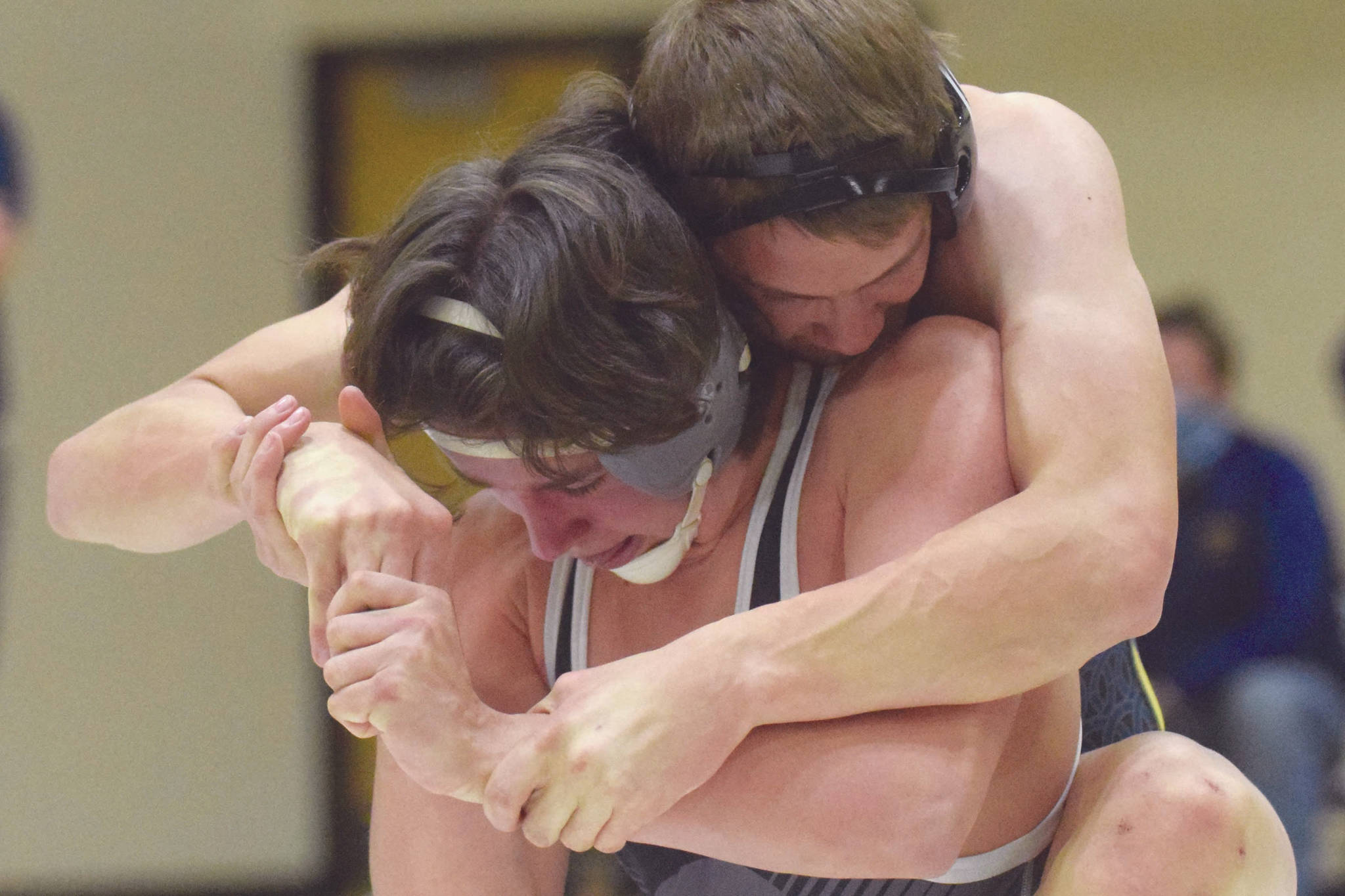 Homer's Nestor Kalugin tries to control Nikiski's Simon Grenier at 171 pounds Tuesday, March 30, 2021, at Nikiski High School in Nikiski, Alaska. Grenier won by 10-4 decision. (Photo by Jeff Helminiak/Peninsula Clarion)