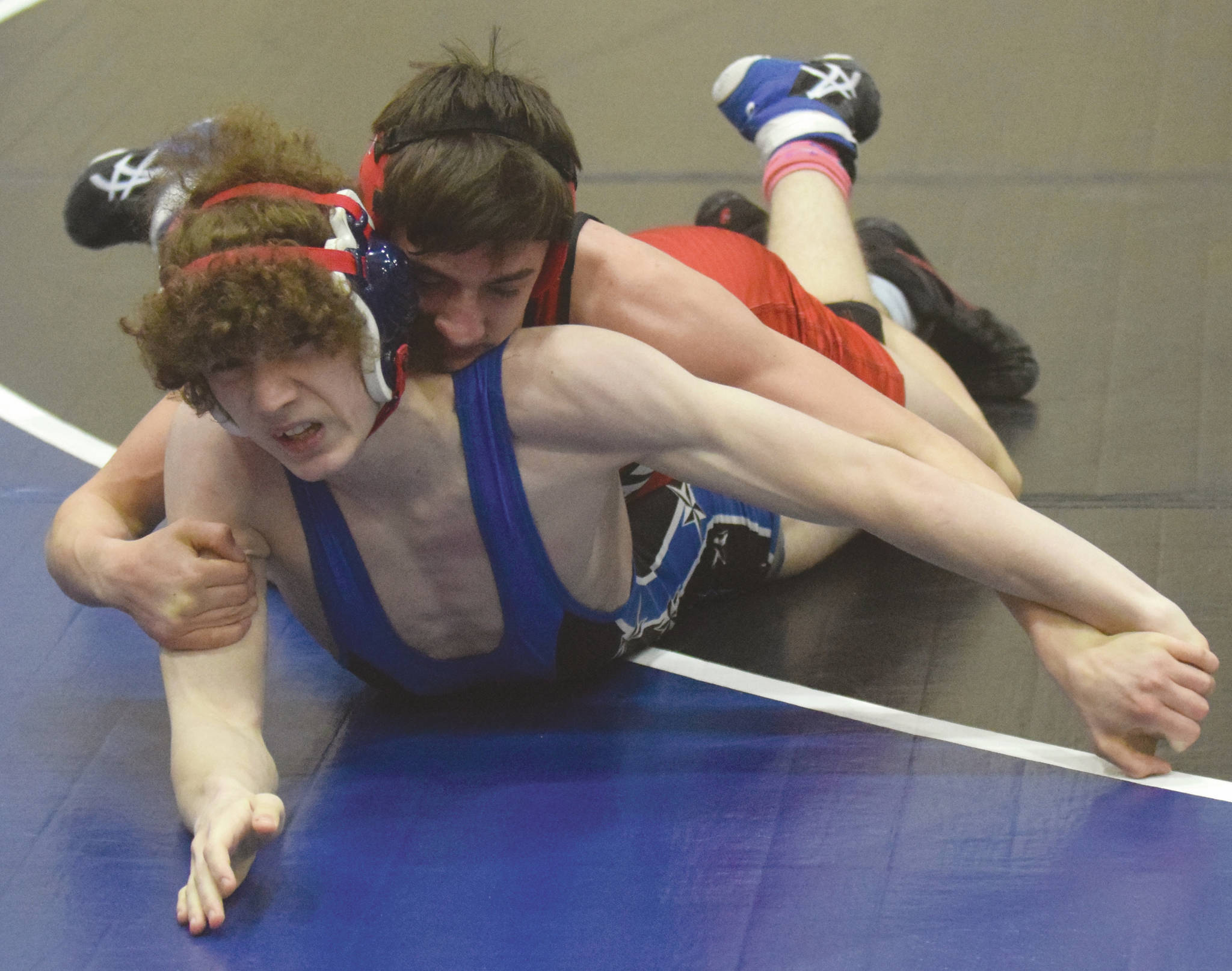 Kenai Central’s Owen Whicker controls Soldotna’s Cassius Miller on the way to a 7-5 victory Friday, April 2, 2021, at Soldotna High School in Soldotna, Alaska. (Photo by Jeff Helminiak/Peninsula Clarion)