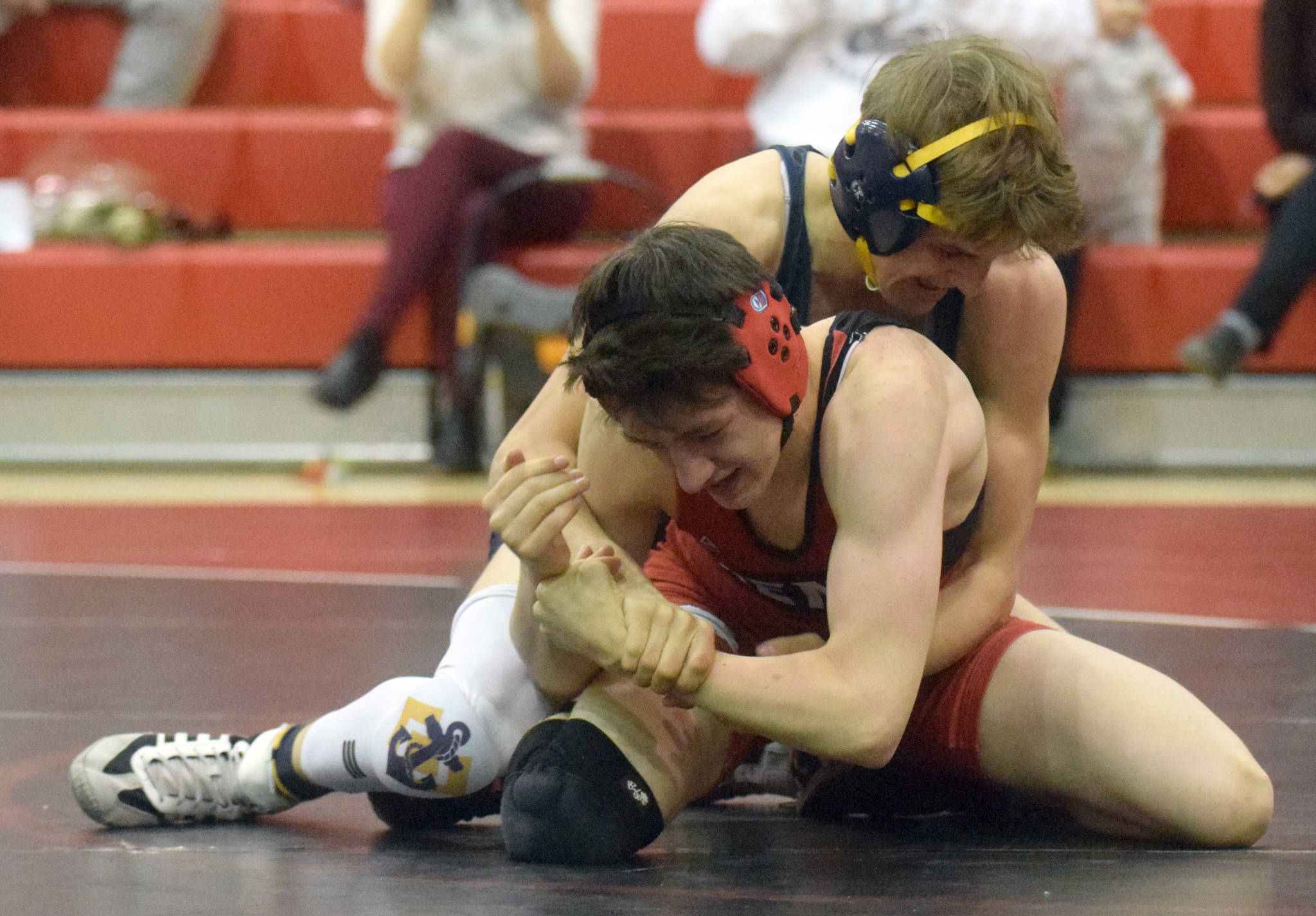 Photo by Jeff Helminiak/Peninsula Clarion 
Homer’s Austin Cline wrestles to a 20-13 decision over Kenai Central’s Talon Whicker at 135 pounds Tuesday, April 27, 2021, at Kenai Central High School in Kenai, Alaska.