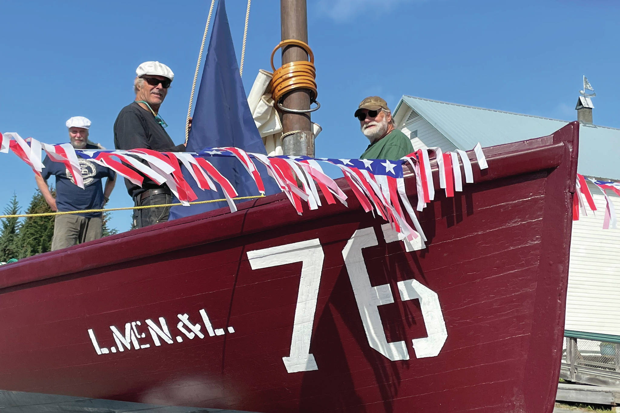 Dave Collette-Paule, left, Dave Seaman, center, and Mike Kennedy, right ready No. 76 for Homer's Fourth of July Parade on Sunday, July 4, 2021, in Homer, Alaska. (Photo by McKibben Jackinsky)