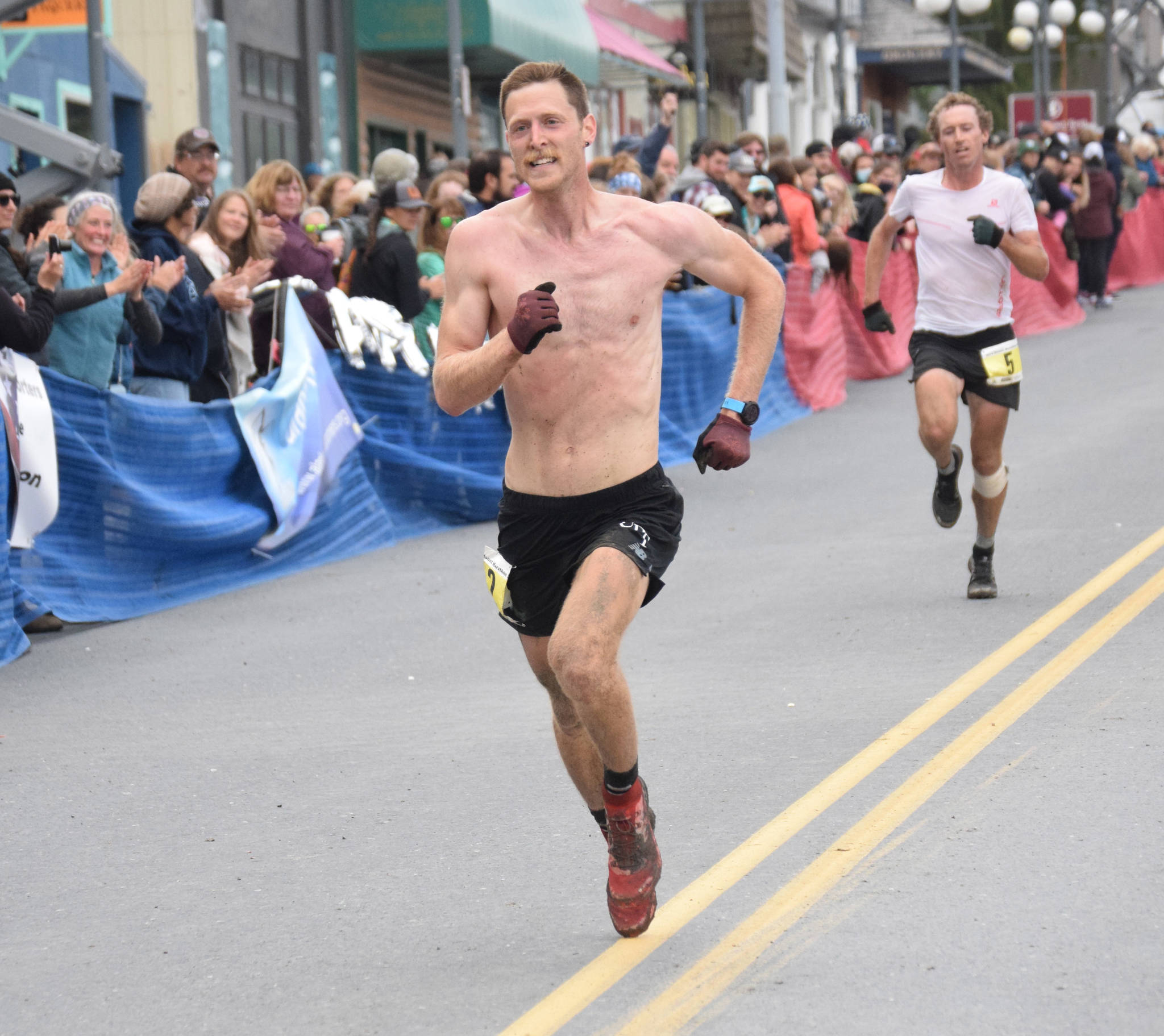 Anchorage’s Lars Arneson outsprints Dakota Jones of Bozeman, Montana, for sixth place in the men’s Mount Marathon Race on Wednesday, July 7, 2021, in Seward, Alaska. (Photo by Jeff Helminiak/Peninsula Clarion)