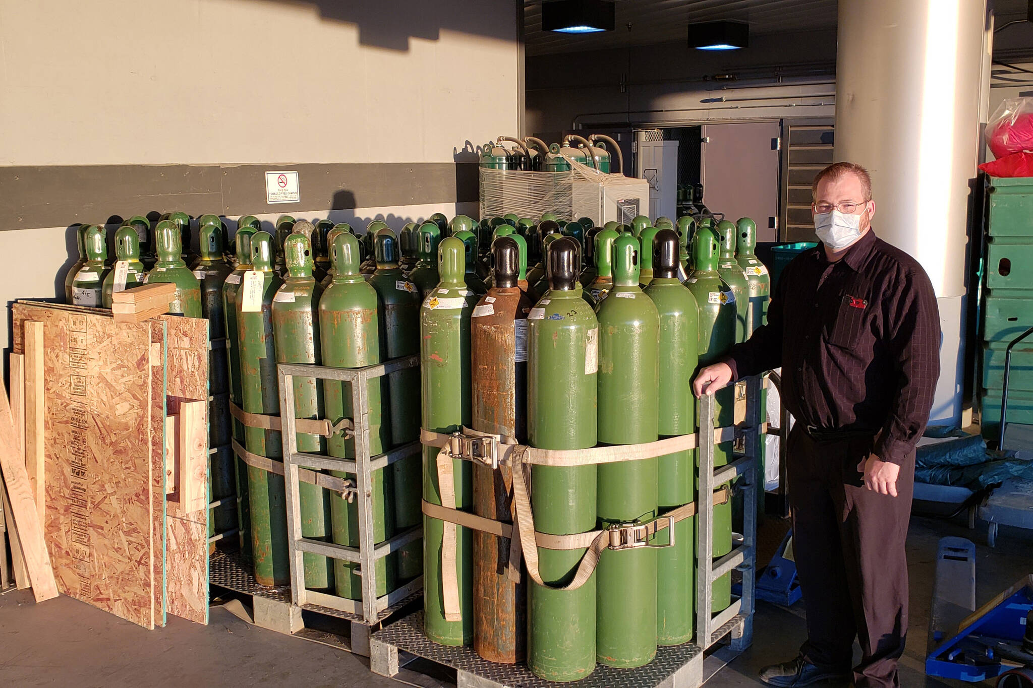 Harrison Smith, South Peninsula Hospital Facilities Manager, stands by medical oxygen tanks on Tuesday, Sept. 22, 2021, at the hospital in Homer, Alaska.  Smith, a certified medical gas technician, has been involved with the med-gas system management at South Peninsula Hospital for 18 years. (Photo by Derotha Ferraro / South Peninsula Hospital)