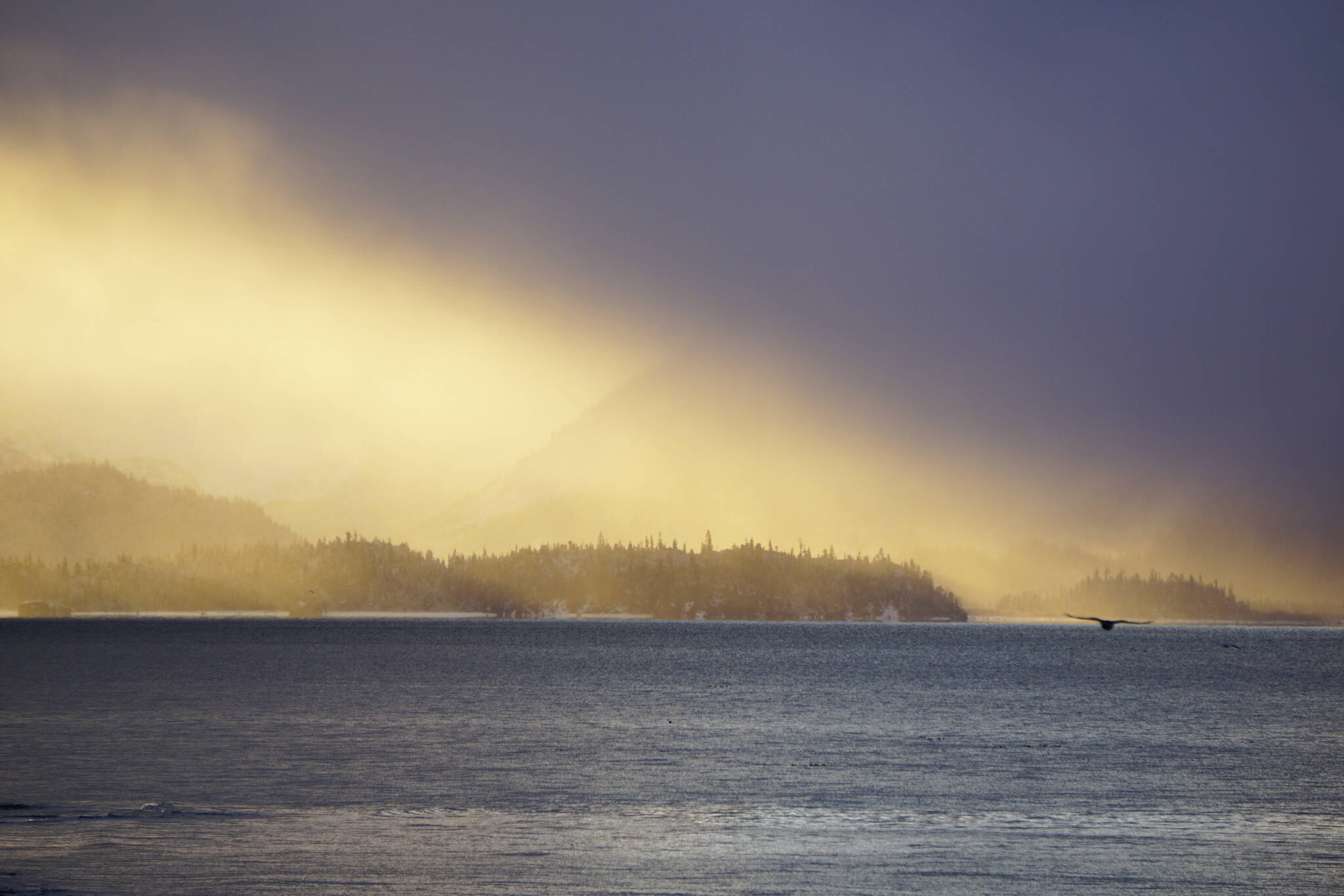 The sun shines on Yukon Island on Thurday, Oct. 28, 2021, as seen from Bishop’s Beach in Homer, Alaska. (Photo by Michael Armstrong/Homer News)