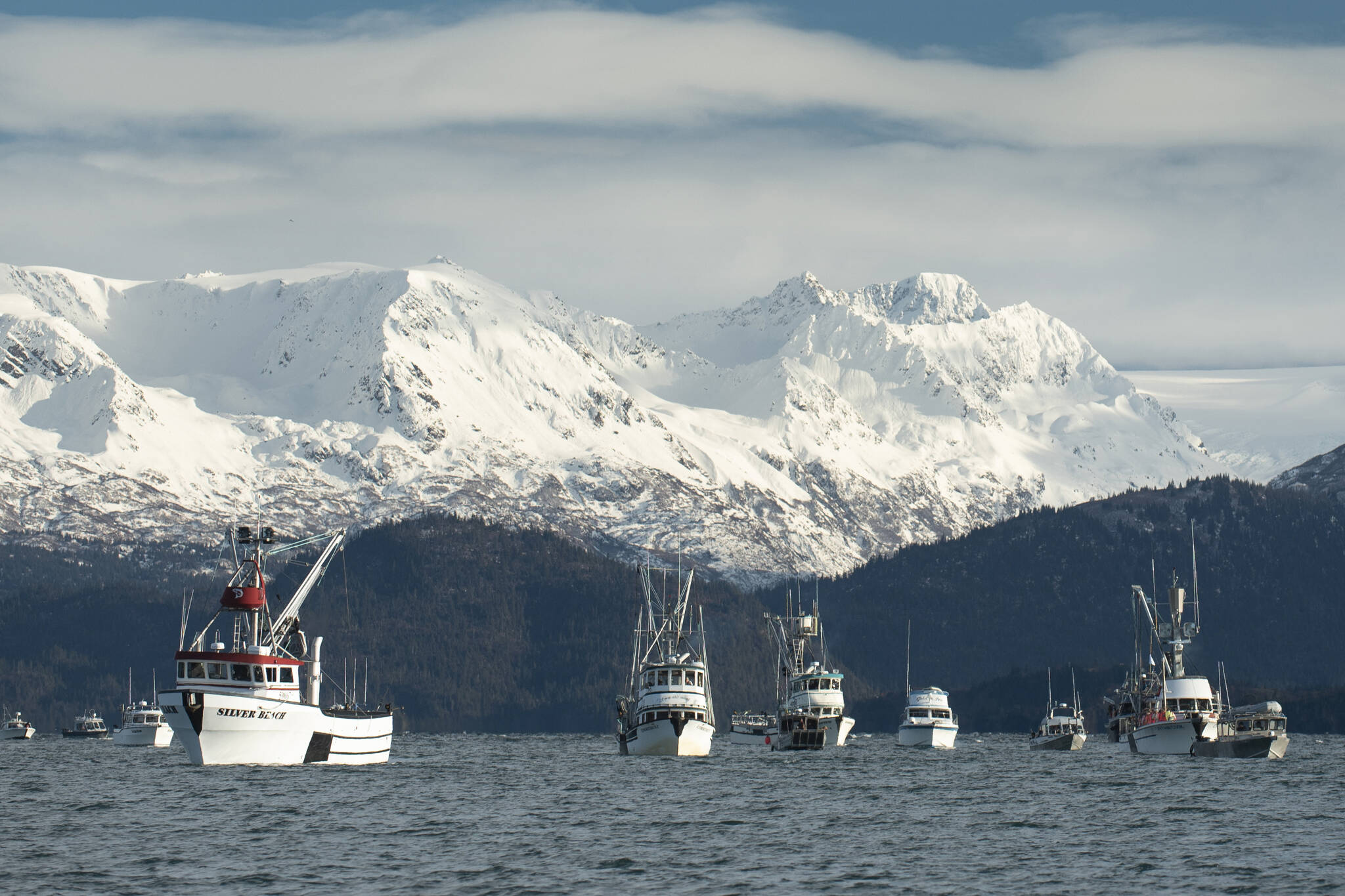 More than 30 boats and 300 people gathered Sunday, Nov. 7, 2021, at Homer’s Seafarer’s Memorial to give a fisherman’s send off for local charter captain Josh Brooks. Brooks, 45, died of a sudden heart attack in Mexico on Oct. 11, 2021, while on vacation at a fishing tournament there. A long-time charter captain and commercial fisherman, Brooks ran his boat, the Huntress, year-round, targeting halibut and salmon. Boat captains fired off expired distress flares and radioed Josh as “missing” in the community’s farewell to a well-loved son. (Photo by Jim Lavrakas)