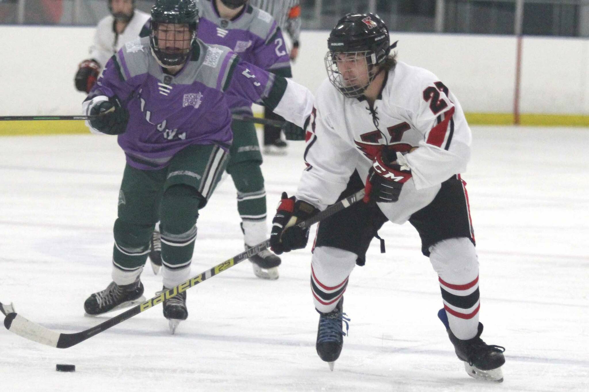 Kenai Central’s Ayden Spann skates the puck across the blue line during a 4-1 loss to Colony during the second day of the 2021 Alaska Army National Guard Stars and Stripes Showdown on Friday, Nov.12, 2021, at the MTA Events Center in Palmer, Alaska. (Photo by Jeremiah Bartz/Frontiersman)