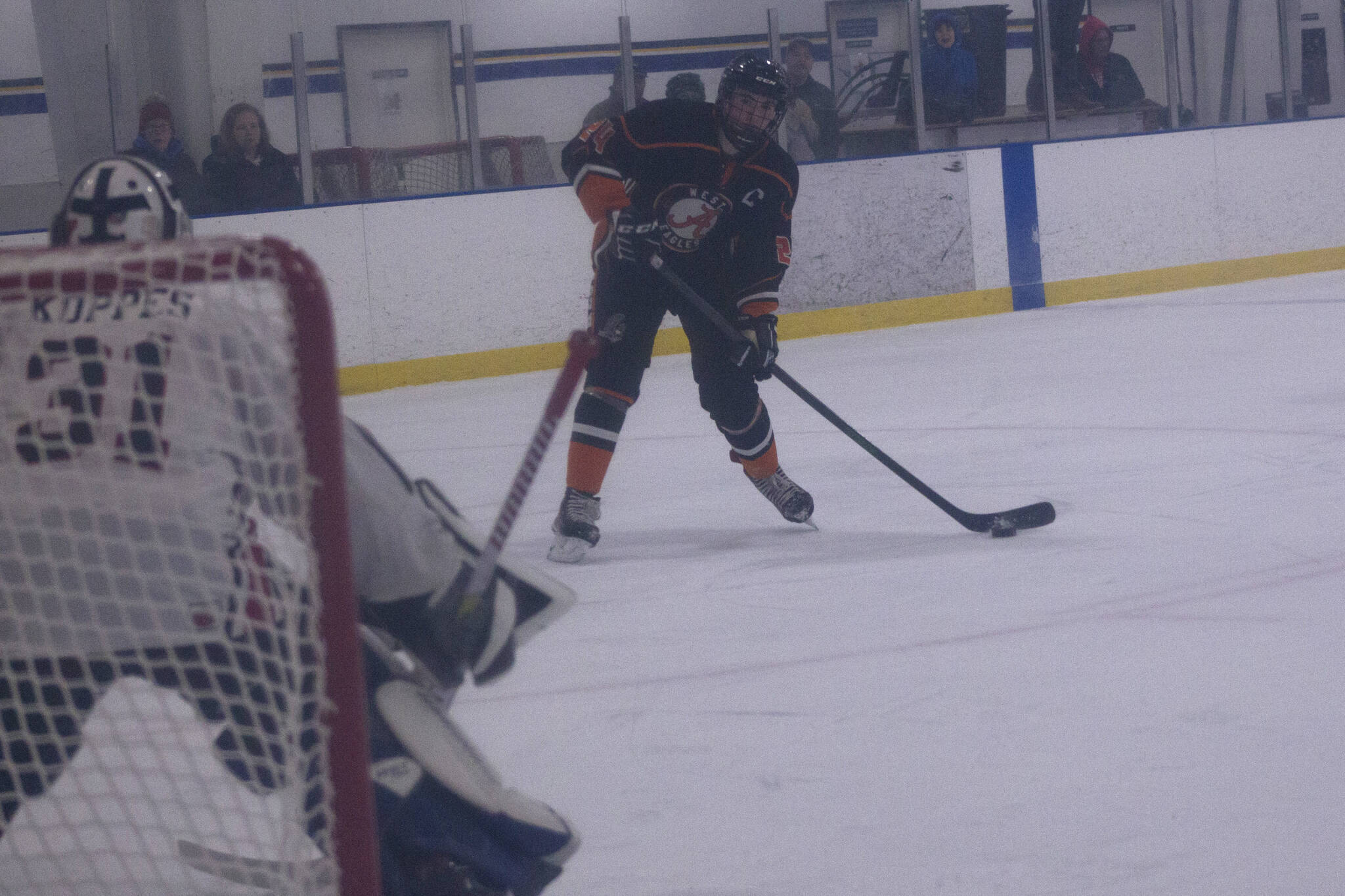 West Anchorage High School's Marty Tumey lines up the puck to score against Kenai during the End of the Road Tourney in Homer Friday, Nov. 18. (Photo by Sarah Knapp/Homer News)