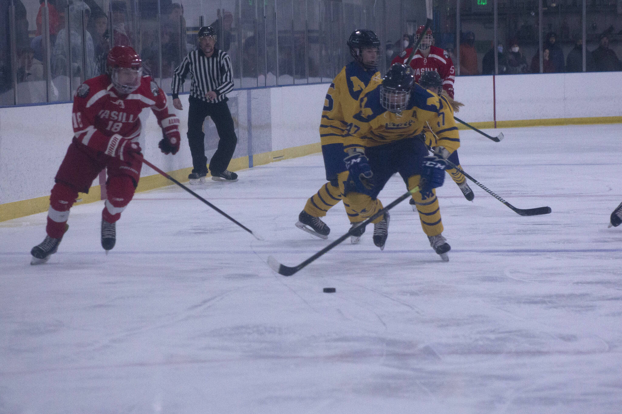 Mariner's Micah Williamson steals the puck from the Warrior's Karson McGrew as he advances down the rink. (Photo by Sarah Knapp/Homer News)