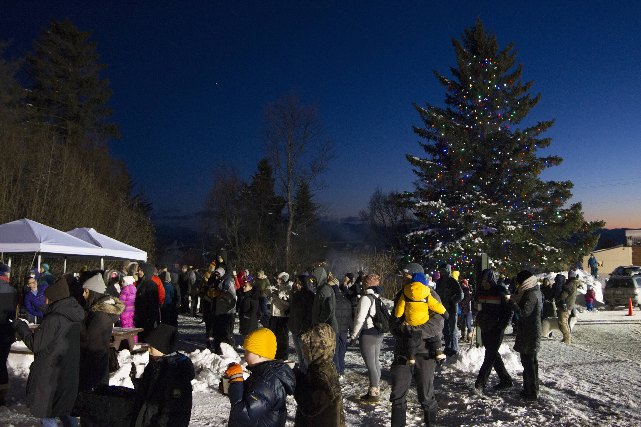 ”O Christmas Tree, O Christmas tree, of all the trees most lovely.” Dozens of community members gathered at the Homer Chamber of Commerce holiday tree lighting ceremony to hear carols and enjoy the holiday season. (Photo by Sarah Knapp/Homer News)