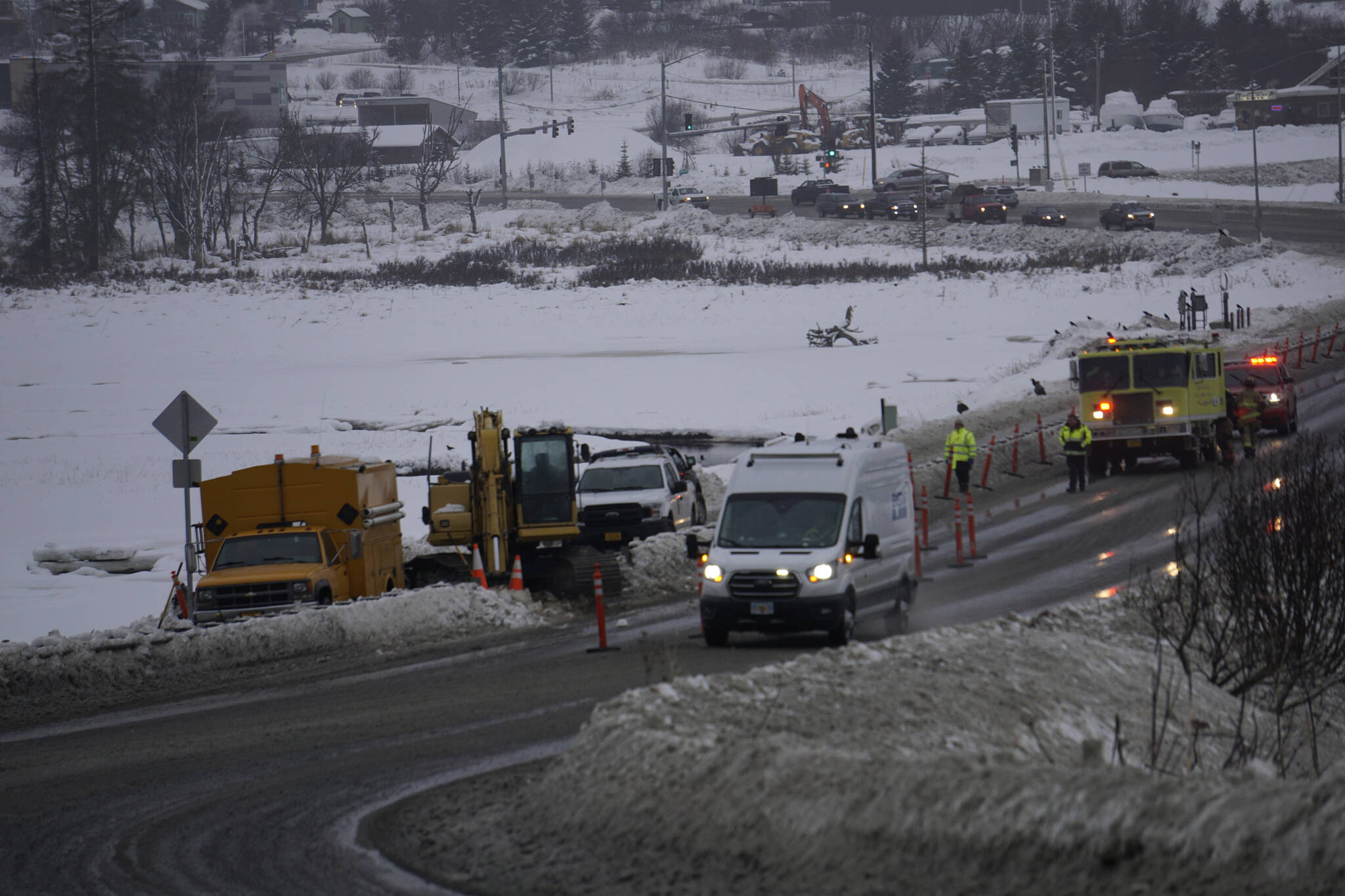 Homer Volunteer Fire Department firefighters respond to a natural gasline break on Lake Street at the Beluga Lake causeway at about 12:30 p.m. Monday, Dec. 20, 2021, in Homer, Alaska. (Photo by Michael Armstrong/Homer News)