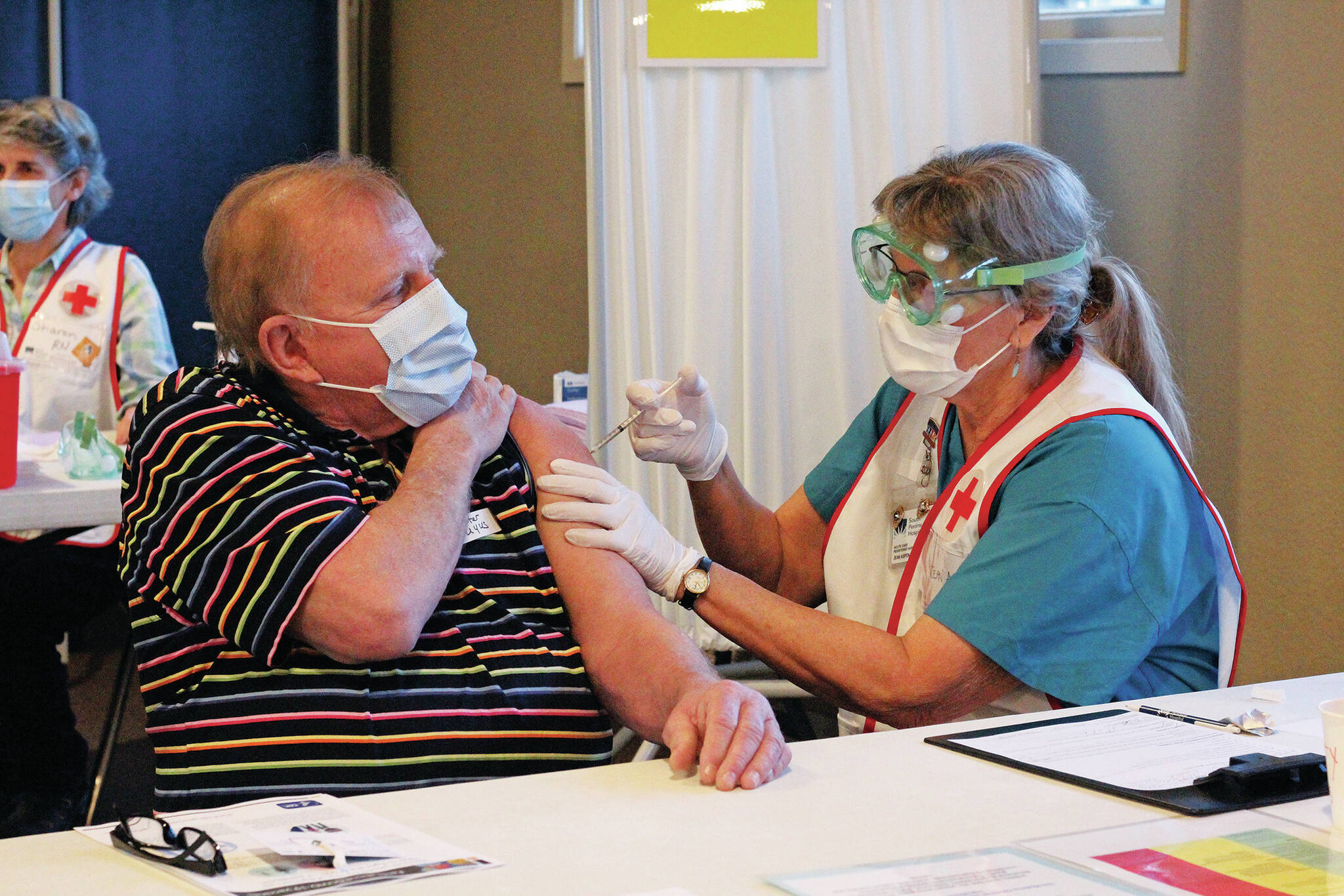 Peter Zuyus receives his first dose of the Moderna vaccine Friday, Jan. 15, 2021 at a large-scale clinic put on by South Peninsula Hospital and the City of Homer at Christian Community Church in Homer, Alaska. (Photo by Megan Pacer/Homer News)