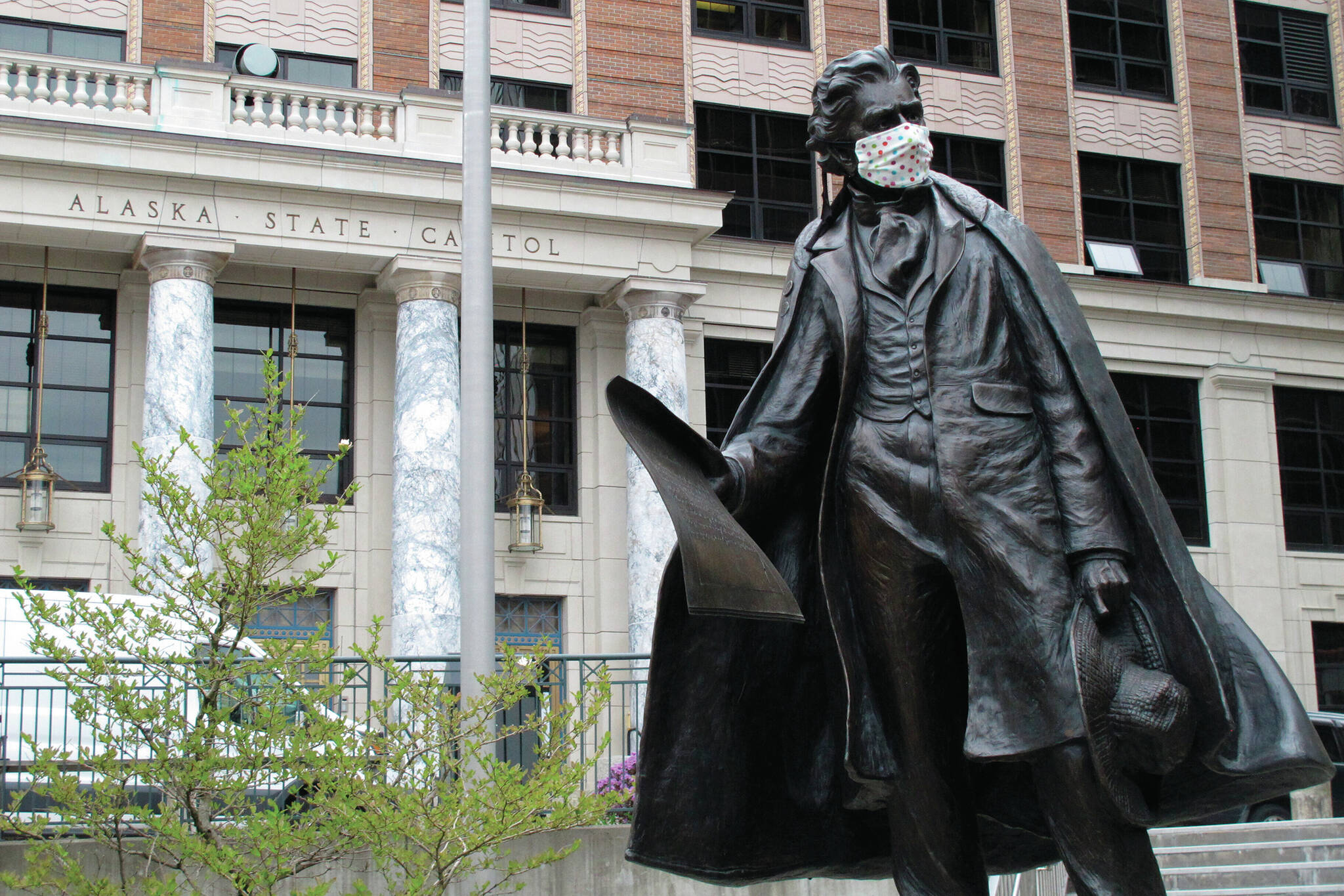 A statue of William Seward wears a mask outside the Alaska Capitol on Monday, May 18, 2020, in Juneau, Alaska. The Alaska Legislature planned to reconvene Monday to address use of federal coronavirus relief funds, with protocols in place aimed at guarding against the virus. (AP Photo/Becky Bohrer)