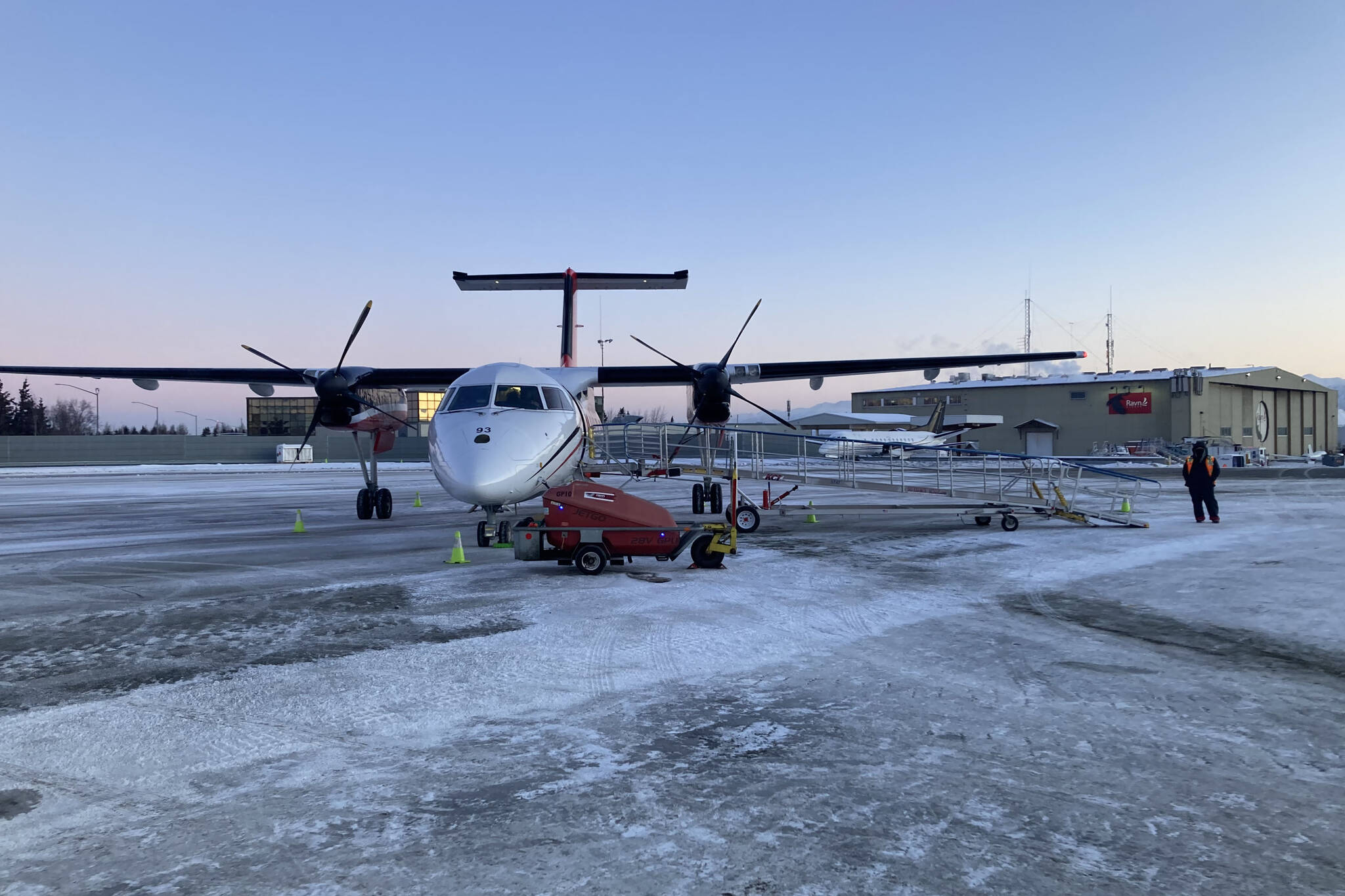 A Ravn Airlines plane arrives in Anchorage to transport passengers to Kenai after more than two hours of delay on Monday, Jan. 3, 2022. Windy conditions stranded many passengers returning to the peninsula over the weekend. (Camille Botello/Peninsula Clarion)