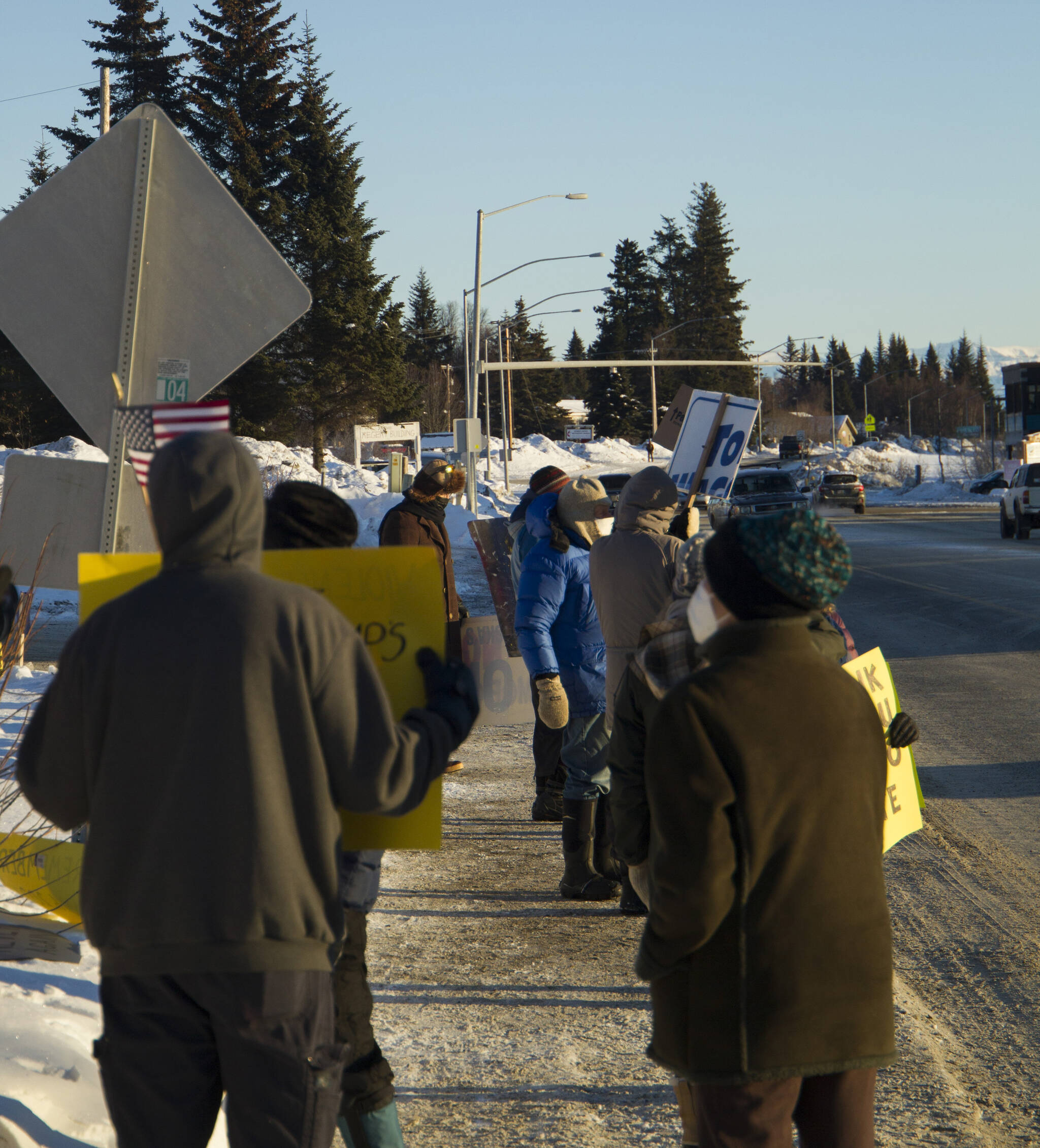 Protesters of the Jan. 6 U.S. Capitol insurrection waves signs toward oncoming traffic at WKFL Park on Thursday, Jan. 6, promoting the right to vote and challenging people to protect democracy. (Photo by Sarah Knapp/Homer News)