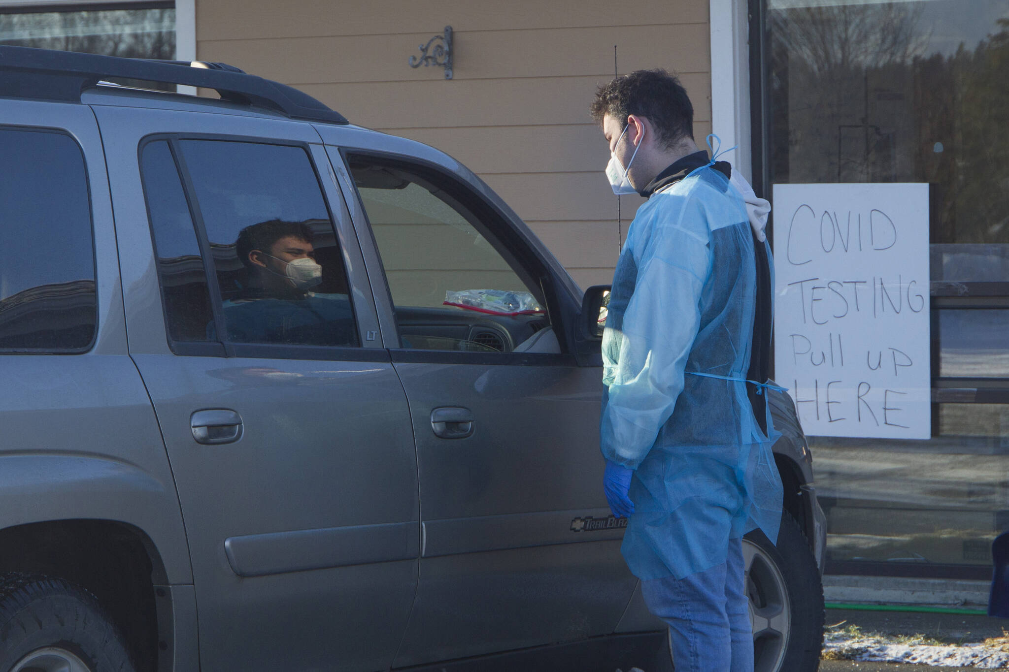 A COVID-19 test administrator discusses the testing process with a patient during the popup rapid testing clinic at Homer Public Health Center on Tuesday, Jan. 25, 2022, in Homer, Alaska. (Photo by Sarah Knapp/Homer News)