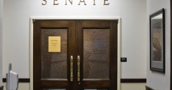 The doors of the Alaska Senate chambers were shut Friday, Oct. 8, 2021, a week into the Alaska State Legislature’s fourth special session of the year. Gov. Mike Dunleavy called lawmakers to session to resolve the state’s longterm fiscal issues, but the same divisions that have kept lawmakers from finding resolution before are still in place. (Peter Segall / Juneau Empire)