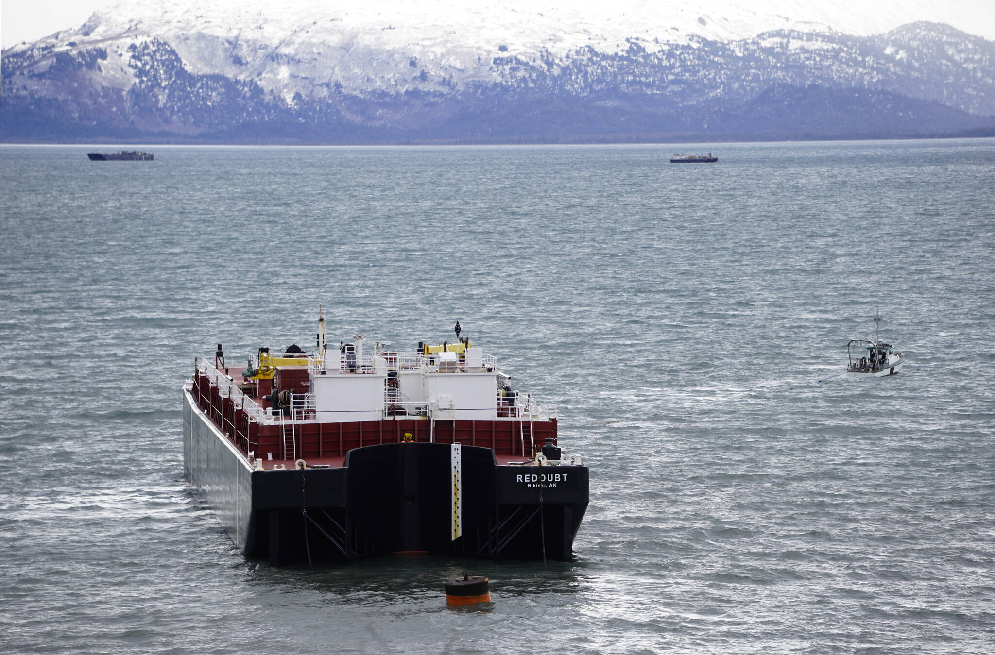 The Alan G with C & C Diving and Salvage tows the Cook Inlet Spill Prevention and Response Inc. barge Redoubt away from the Mud Bay beach in Kachemak Bay off Kachemak Drive at about 2:20 p.m. Thursday, March 31, 2022, in Homer, Alaska. (Photo by Michael Armstrong/Homer News)