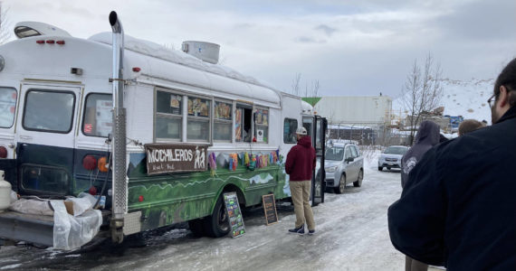 People wait in line for Mochileros Guatemalan street food in Anchorage, Alaska, on March 18, 2022. (Camille Botello/Peninsula Clarion)