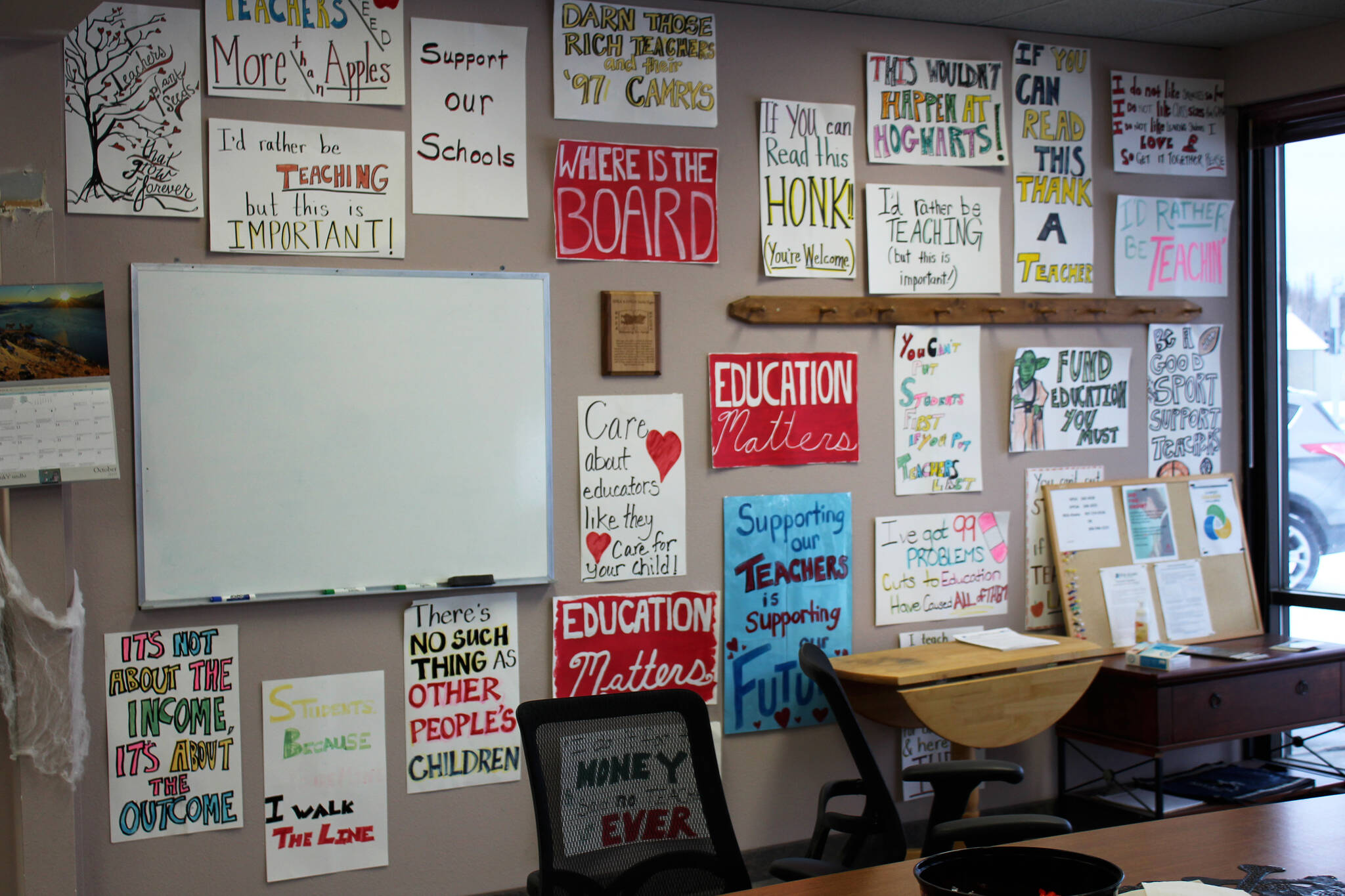 Signs hang on the entryway wall at the Kenai Peninsula Education Association office in Soldotna, Alaska, in this Thursday, Oct. 28, 2021, file photo. (Ashlyn O’Hara/Peninsula Clarion)