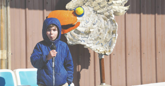 Eli Springer of Fairbanks does his impression of an eagle call for the Homer Brewing Company's bird calling contest during the Kachemak Bay Shorebird Festival on Saturday, May 7, 2022, in Homer, Alaska. The winner of the serious bird call contest was Cohen McBride of Homer, with his eagle call. (Photo by Michael Armstrong/Homer News)
