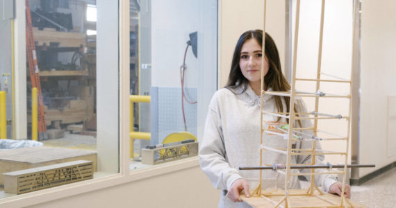 ANSEP Acceleration Academy (Summer) student Alivia Fefelov poses on Tuesday, June 21, 2022, at the University of Alaska Anchorage with a balsa tower she helped build to learn about engineering structures to survive earthquakes. The tower withstood a simulated earthquake. (Photo provided)