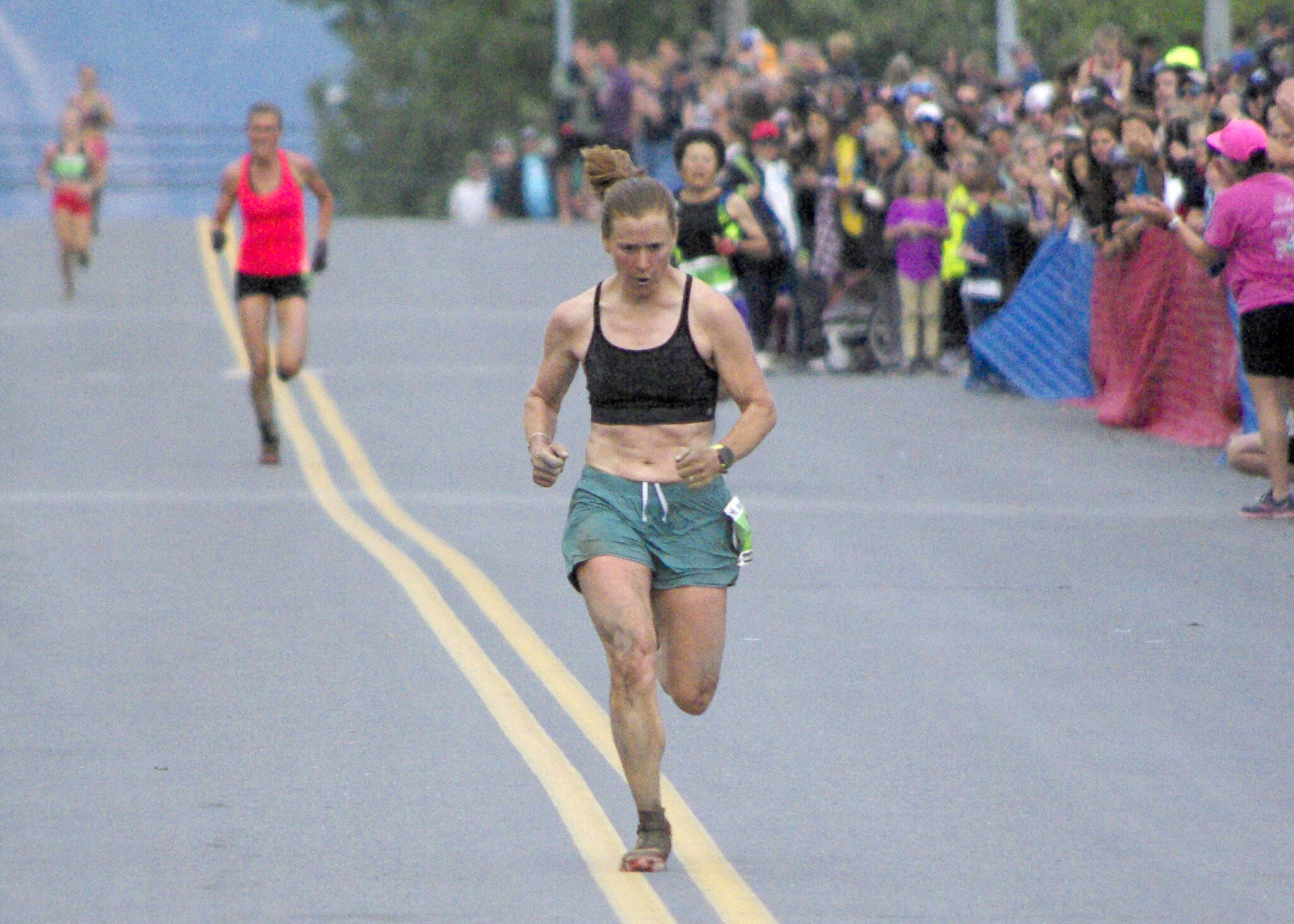 Seward’s Hannah Lafleur leads a trail of runners to the finish to take second in the women’s Mount Marathon Race on Monday, July 4, 2022, in Seward, Alaska. (Photo by Jeff Helminiak/Peninsula Clarion)