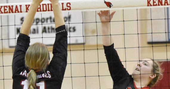 Houston’s Alycen Hunter attacks on Kenai Central’s Grace Beiser on Friday, Nov. 4, 2022, at the Southcentral Conference volleyball tournament at Kenai Central High School in Kenai, Alaska. (Photo by Jeff Helminiak/Peninsula Clarion)