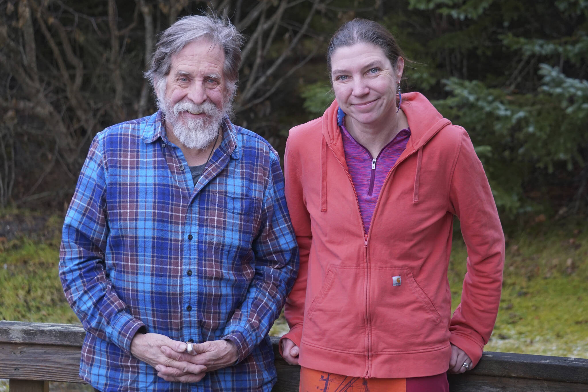 Homer News Editor Michael Armstrong, left, and Senior Reporter Emilie Springer, right, pose for a photo on Tuesday, Dec. 6, 2022, at the newspaper office in Homer, Alaska. (Photo by Charlie Menke/Homer News)