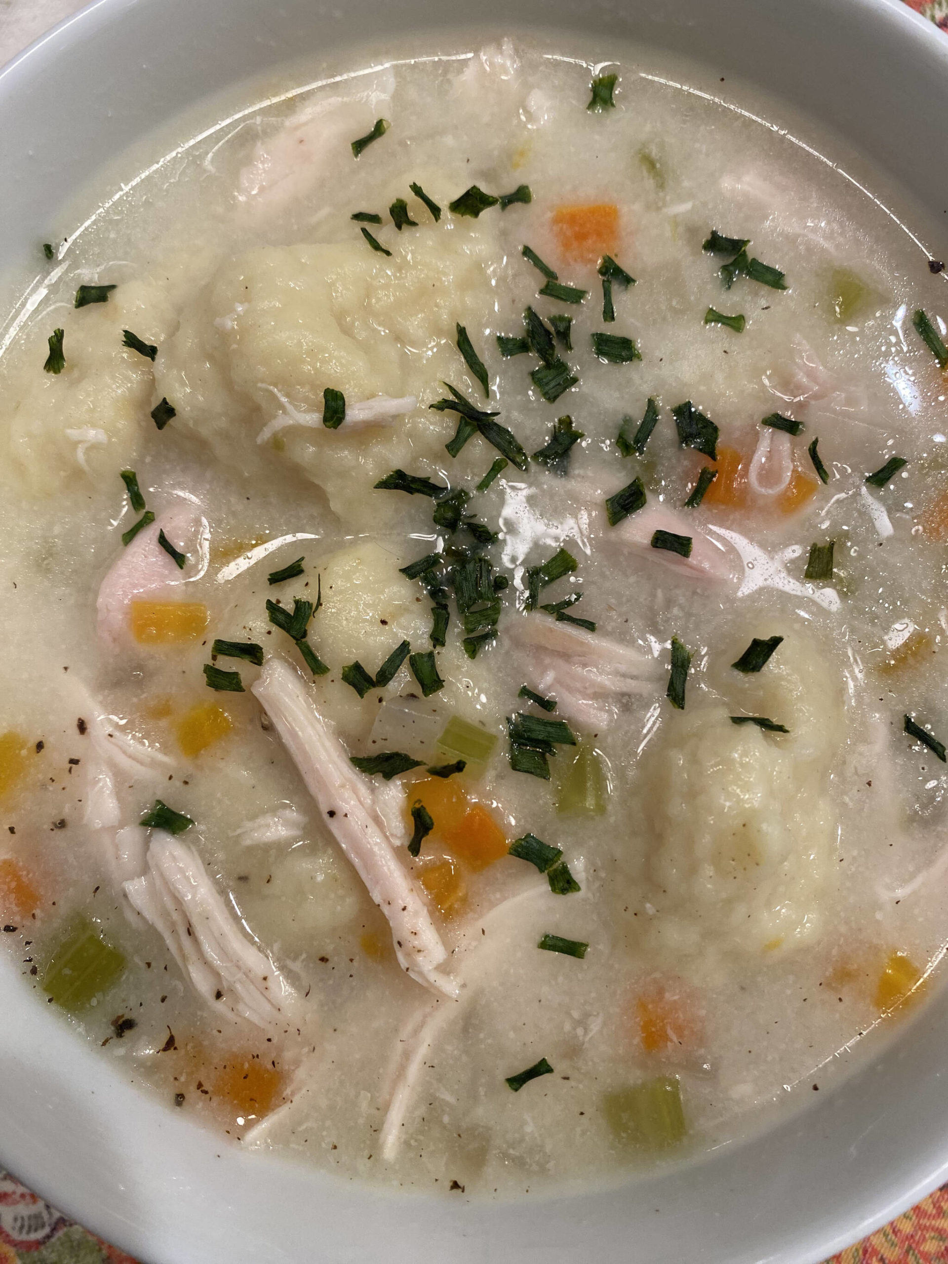 Onions, carrots and chicken broth are topped off with warm dumplings in this classic recipe. (Photo by Tressa Dale/Peninsula Clarion)