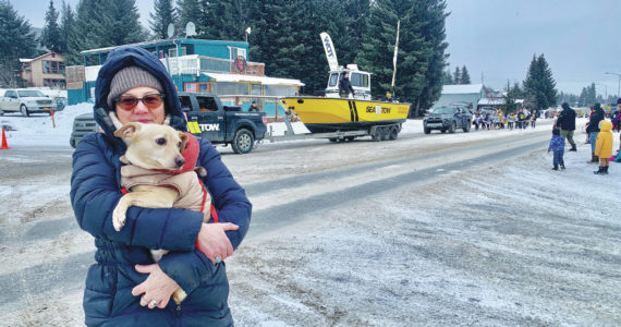Jennifer Gibbons and her dog Tiptoe enjoy the Homer Winter Carnival parade on Saturday, Feb. 11, 2023. (Photo by Christina Whiting/Homer News)