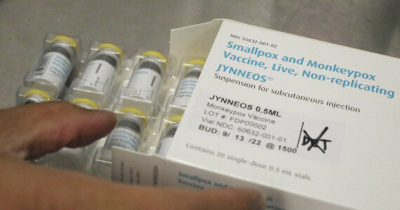 Jonathan Parducho, a pharmacist, removes a tray of vials of of the Jynneos vaccine for monkeypox from a box containing 20 doses, in the vaccine hub at Zuckerberg San Francisco General Hospital on Friday, July 29, 2022, in San Francisco. (Lea Suzuki/San Francisco Chronicle via AP)