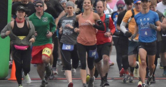 Marathon and half marathon runners begin the Kenai River Marathon on Sunday, Sept. 25, 2022, in Kenai, Alaska. At the front are women's marathon winner Amanda Cherok (28), men's half marathon winner Lee Frey (third from right), women's half marathon winner Kristin Davis (242) and men's marathon winner and new event record holder Lars Arneson (36).