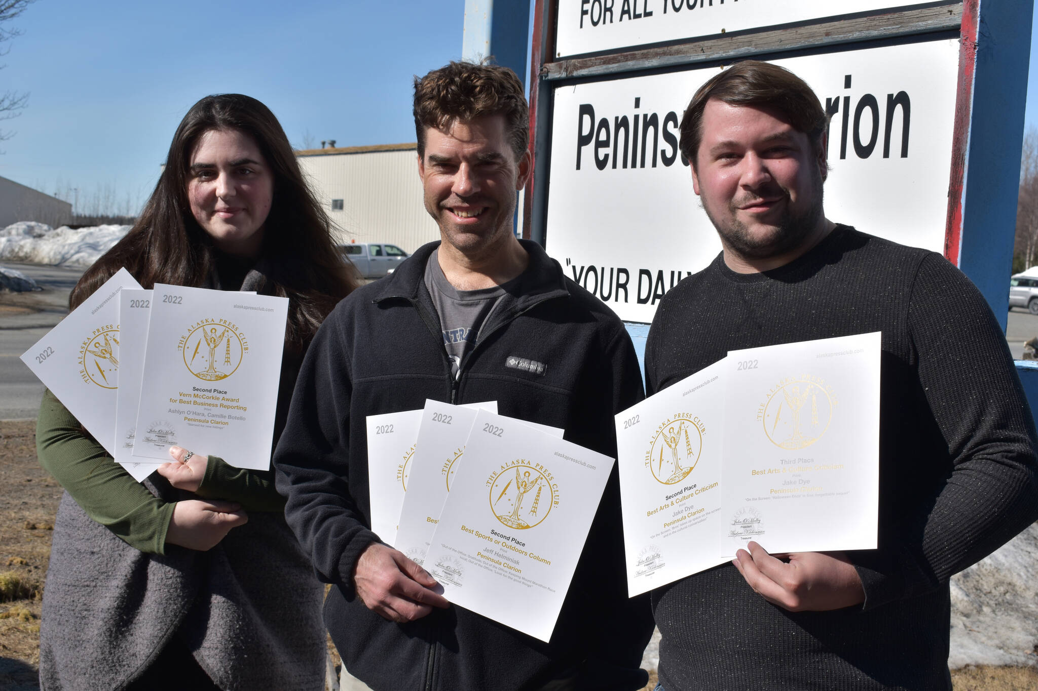 Kenai Peninsula reporter Ashlyn O’Hara, Sports Editor Jeff Helminiak and reporter Jake Dye pose with their 2022 Alaska Press Club awards, Monday, April 24, 2023, in Kenai, Alaska. (Photo by Erin Thompson/Peninsula Clarion)