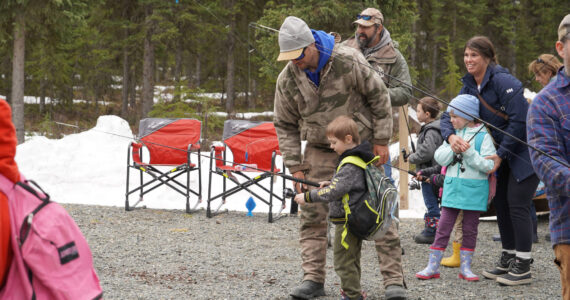 Members of the Kenai River Professional Guide Association teach elementary students to cast a fly rod during Salmon Celebration on Wednesday, May 10, 2023, at Johnson Lake in Kasilof, Alaska. (Jake Dye/Peninsula Clarion)