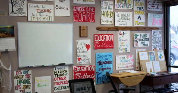 Protest signs hang on the entryway wall at the Kenai Peninsula Education Association office on Thursday, Oct. 28, 2021, in Soldotna, Alaska. (Ashlyn O’Hara/Peninsula Clarion)