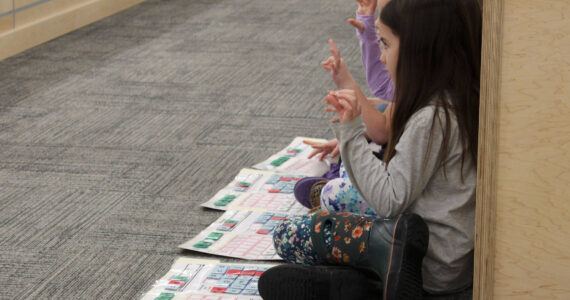 Mountain View Elementary School students use their hands to build works using methodology from the University of Florida Literacy Institute during a board of education meeting on Monday, Dec. 5, 2022, in Soldotna, Alaska. (Ashlyn O’Hara/Peninsula Clarion)