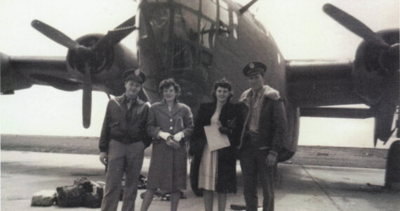 Larry and Rusty Lancashire (at left) pose in front of a B-24 bomber in the early 1940s with another unidentified couple. Larry was a B-24 co-pilot during World War II. (Photo courtesy of the Lancashire Family Collection)