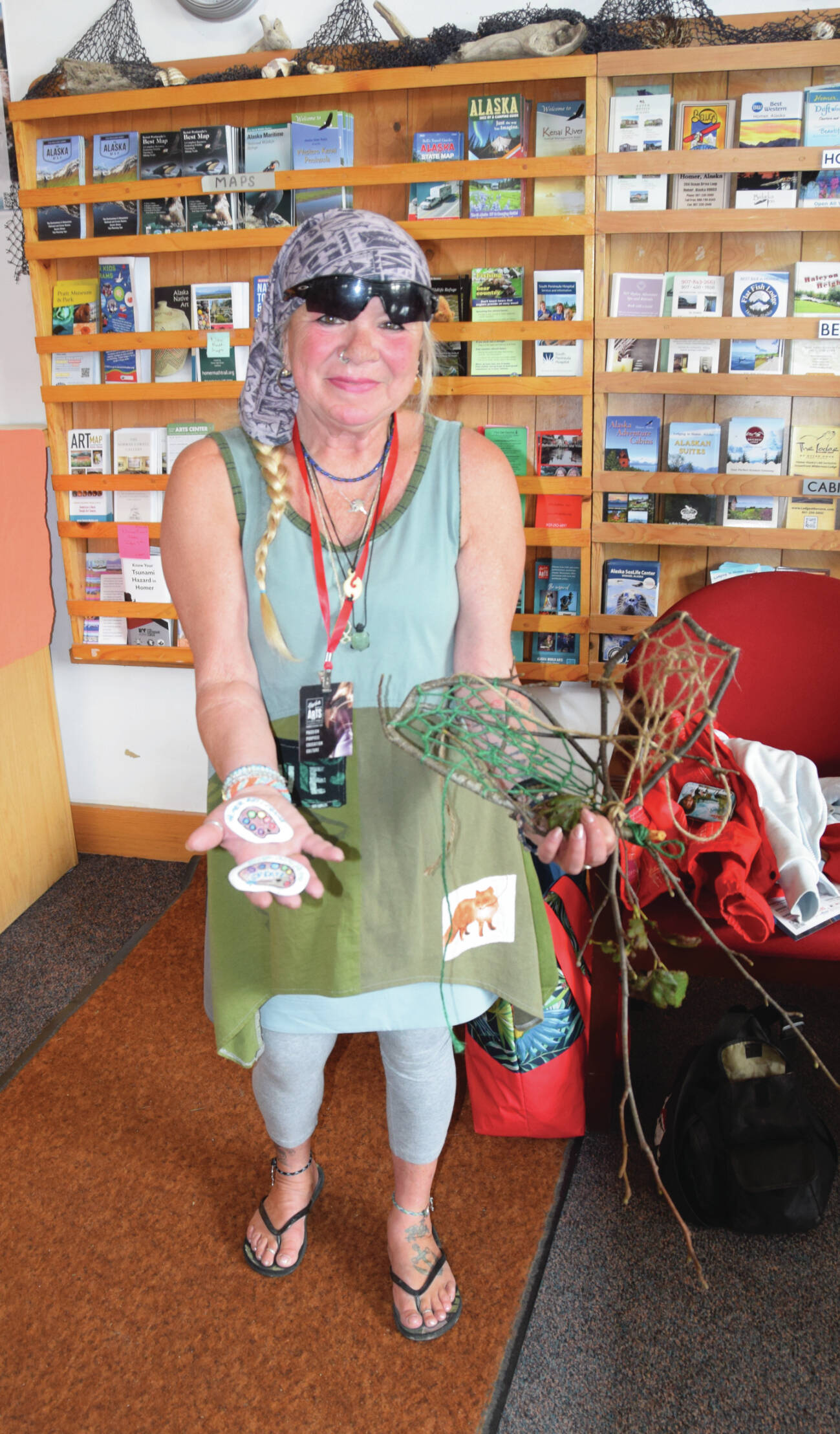 RJ Nelson displays token rocks that will be hidden around town during the arts festival as well as decorations that were included in the burning basket event Sunday at Mariner Park. Emilie Springer/ Homer News