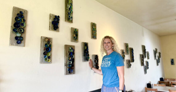 Artist Krista Etzwiler hangs her ceramic pinch pots on reclaimed wood at The Bagel Shop on East End Road in August in Homer, Alaska. Photo provided by Krista Etzwiler