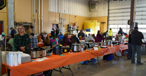 A series of pots full of chili fill tables during Kenai Aviation’s Fifth Annual Pumpkin Drop at the Kenai Municipal Airport Operations Building in Kenai, Alaska, on Saturday, Oct. 21, 2023. (Jake Dye/Peninsula Clarion)