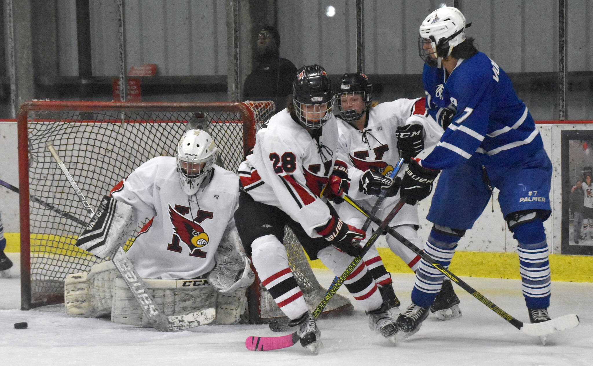 Photo by Jeff Helminiak/Peninsula Clarion
Kenai Central’s Seanna Swanson scrambles to make a save while Cole Langham and Kylee Verkuilen hold off Palmer’s Elijah Von Gunten on Thursday, Nov. 16, 2023, during Kenai River Cup play at the Kenai Multi-Purpose Facility in Kenai, Alaska.