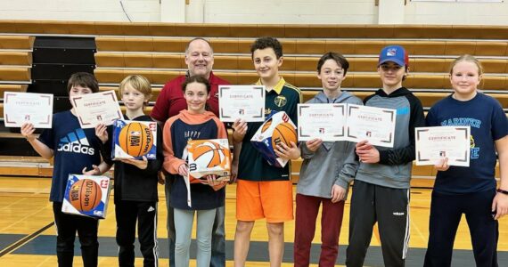 The 2023-2024 Homer Elk’s Lodge Hoop Shoot competition, from left to right: Max Fefelov, Dylan Waltenbough, Dottie Sylce, Andrew Marley, Rio Waltenbough, John Chapple V, Tayla Darr. Back: Heath Smith Elks Hoop Shoot Director, on Saturday, Nov. 24th, in Homer, Alaska.